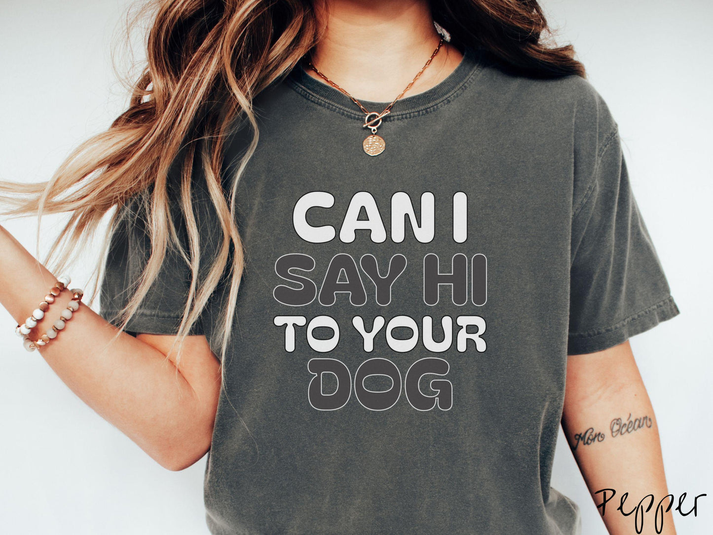 This vintage Comfort Colors t-shirt is perfect for dog lovers who want to make a bold statement. Featuring the text "CAN I SAY HI TO YOUR DOG" in uppercase black and white font, this shirt combines comfort and style with a playful message.