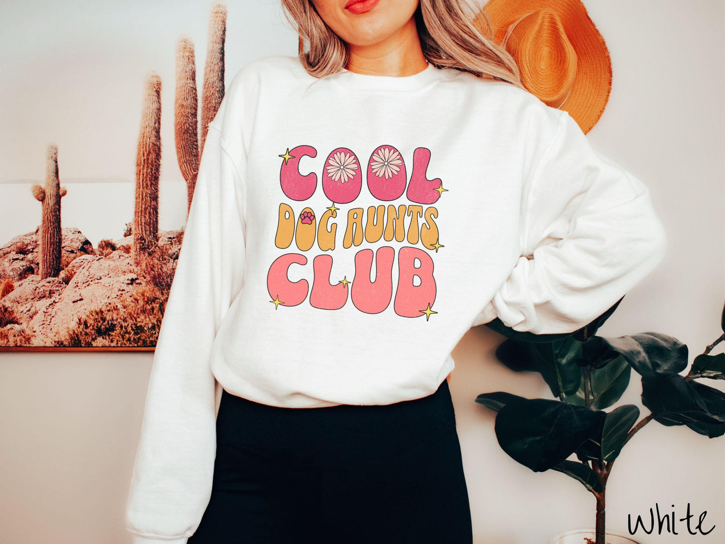 A vintage Gildan sweatshirt featuring the text "Cool Dog Aunts Club" in bold red, yellow, and orange fonts with flower petals nestled in the "O" of COOL, a cute red paw print in the "O" of DOG, and sparkling yellow stars throughout.