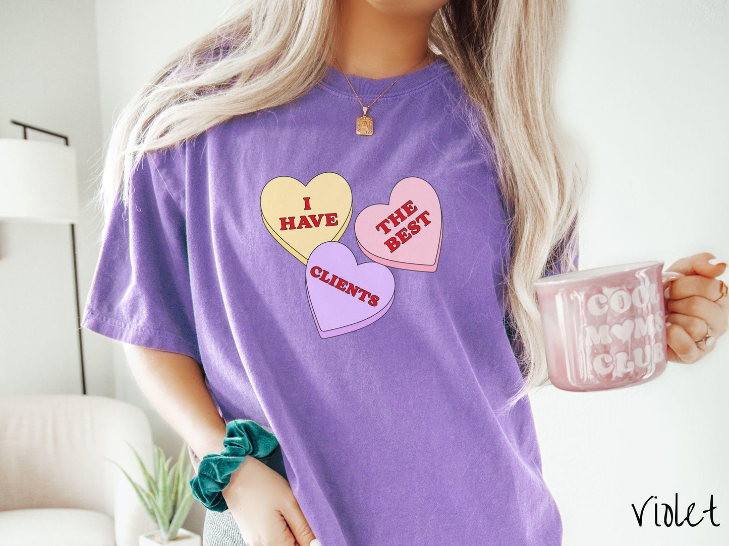 Show your appreciation for your amazing clients with this charming Comfort Colors t-shirt featuring three vibrant conversation hearts in yellow, red, and purple colors showcasing the text “I have the best clients” spread across the hearts.