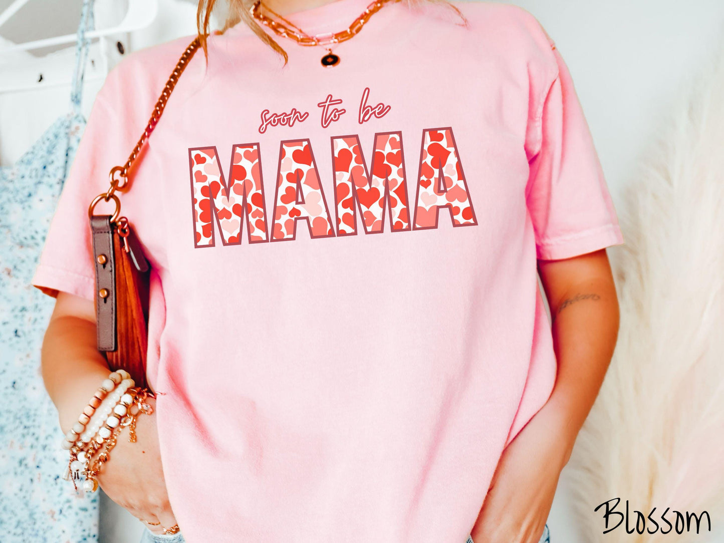 Celebrate your journey to motherhood with this vintage Comfort Colors t-shirt featuring the phrase “Soon to Be Mama” in bold red font, and the word “Mama” stands out in block letters filled with colorful hearts for a playful and charming touch.