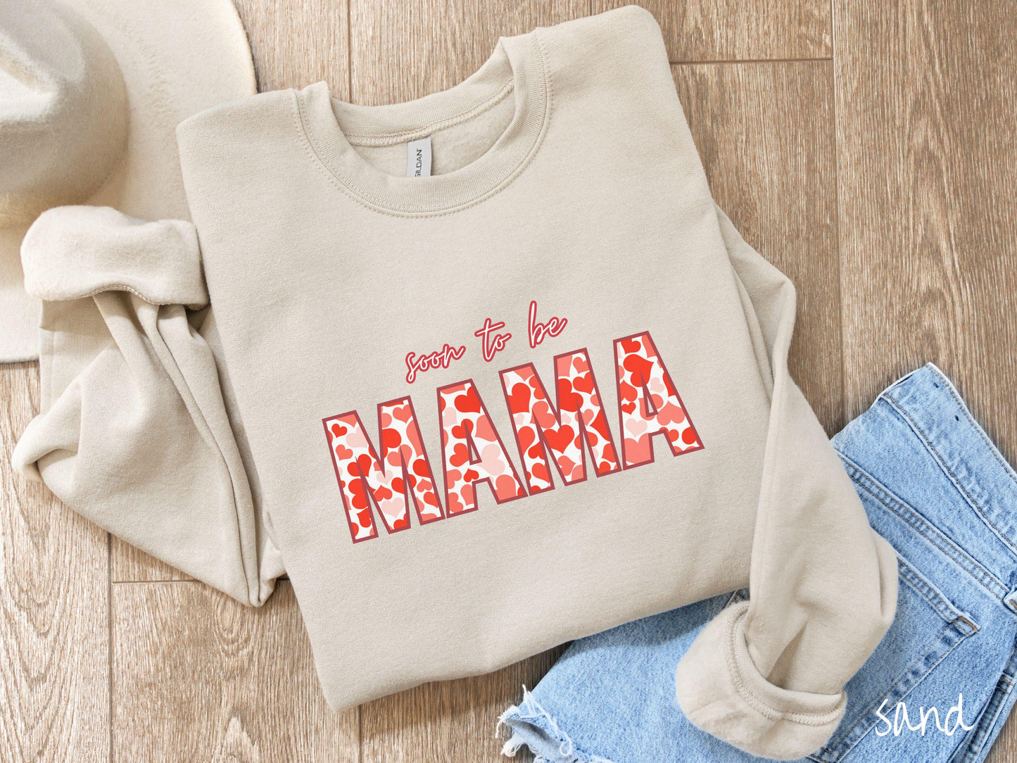 Celebrate your journey to motherhood with this vintage Gildan sweatshirt featuring the phrase “Soon to Be Mama” in bold red font, and the word “Mama” stands out in block letters filled with colorful hearts for a playful and charming touch.