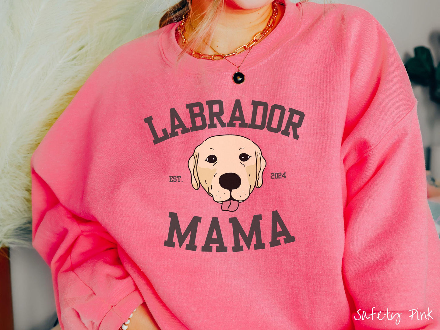 A vintage Gildan sweatshirt featuring bold block lettering that reads 'Labrador Mama.' At the center of the design, a playful yellow Labrador with its tongue out steals the spotlight, framed by the stylish text 'EST. 2024.'