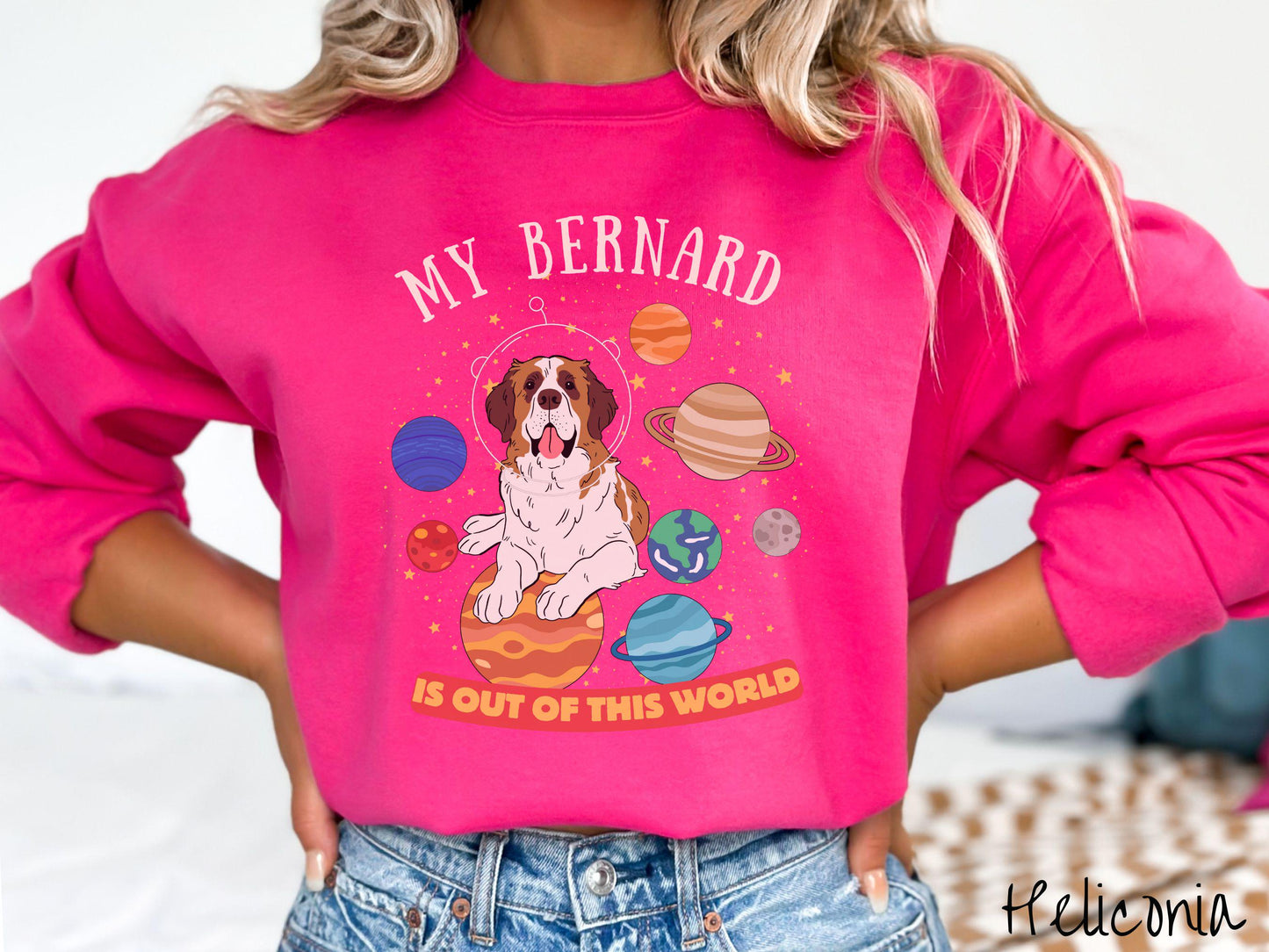 A vintage Gildan sweatshirt featuring the text 'My Bernard is Out of This World'. The design showcases an adorable St. Bernard sitting proudly atop Jupiter, surrounded by a vibrant solar system filled with colorful planets and twinkling stars.
