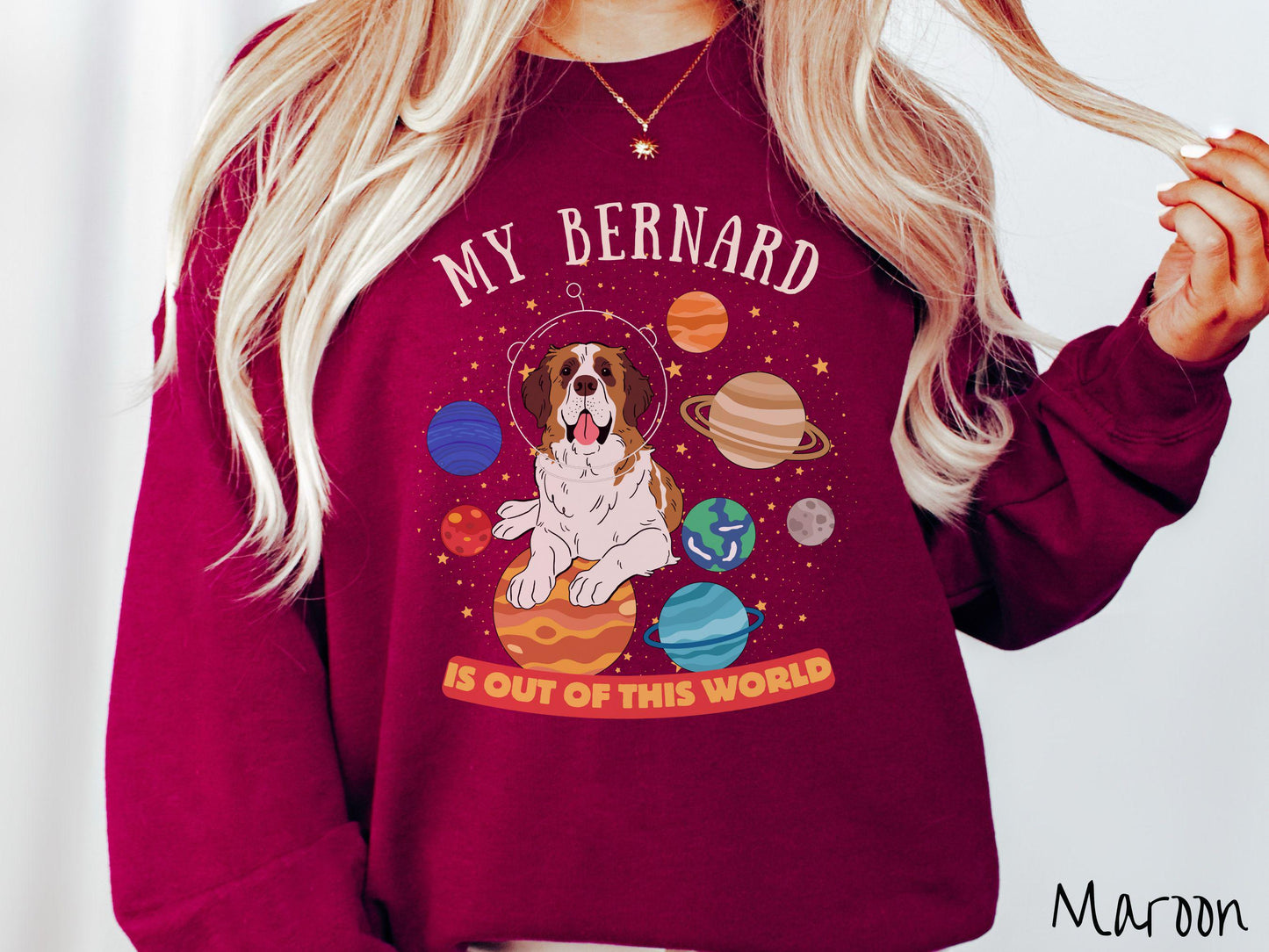 A vintage Gildan sweatshirt featuring the text 'My Bernard is Out of This World'. The design showcases an adorable St. Bernard sitting proudly atop Jupiter, surrounded by a vibrant solar system filled with colorful planets and twinkling stars.