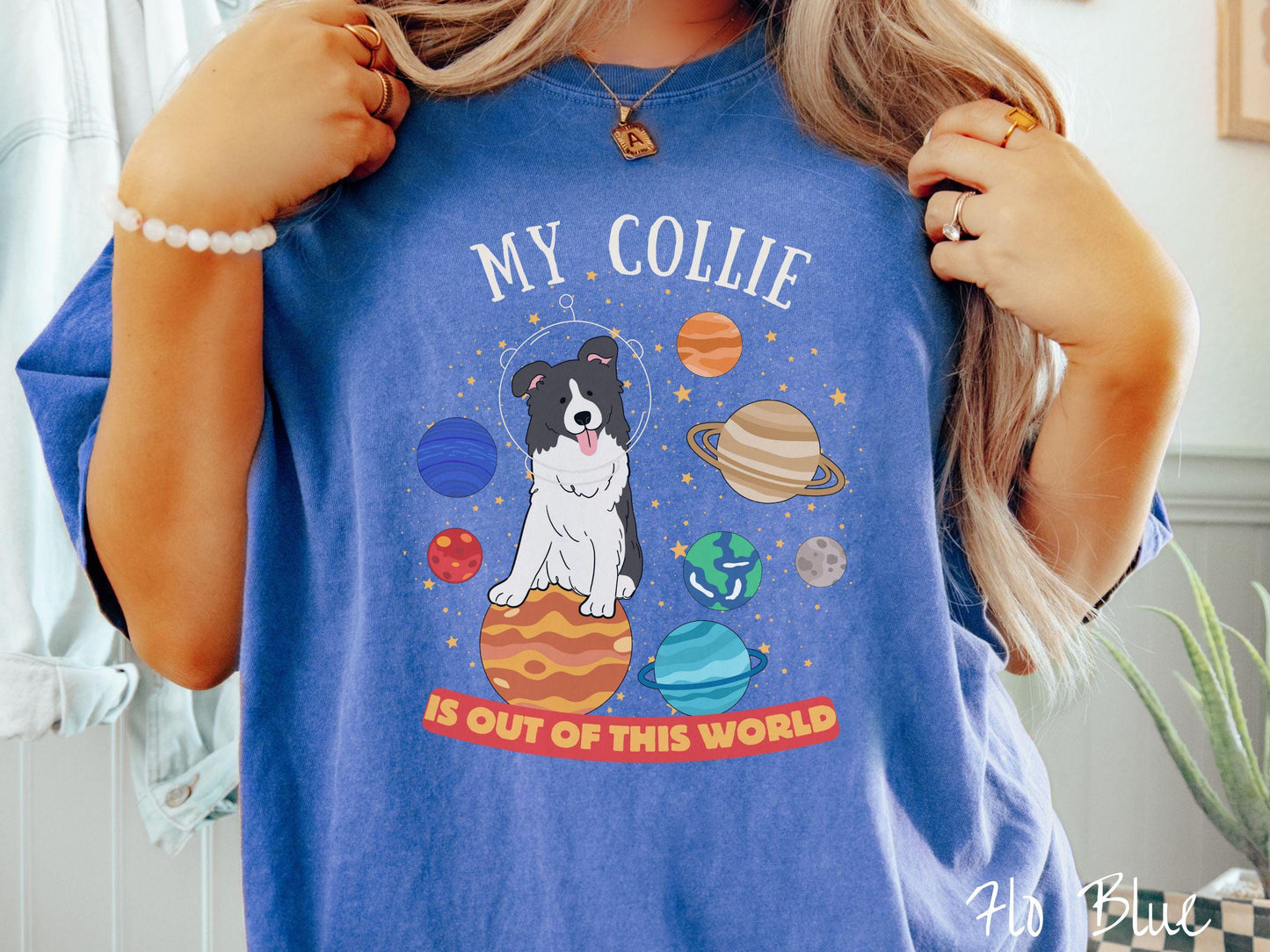 A vintage Comfort Colors t-shirt featuring the text My Collie is Out of This World. The design showcases an adorable Border Collie sitting proudly atop Jupiter, surrounded by a vibrant solar system filled with colorful planets and twinkling stars.