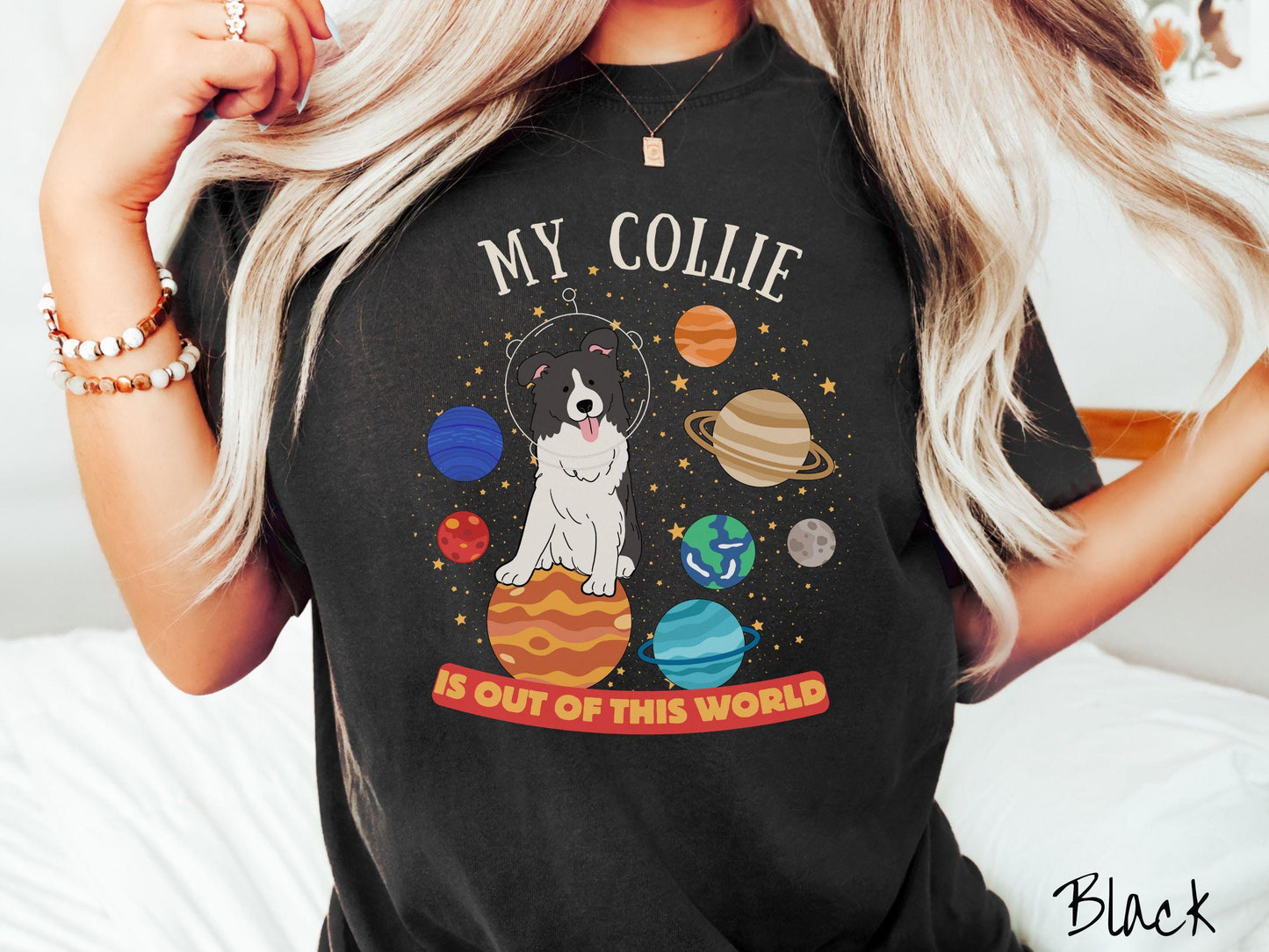 A vintage Comfort Colors t-shirt featuring the text My Collie is Out of This World. The design showcases an adorable Border Collie sitting proudly atop Jupiter, surrounded by a vibrant solar system filled with colorful planets and twinkling stars.
