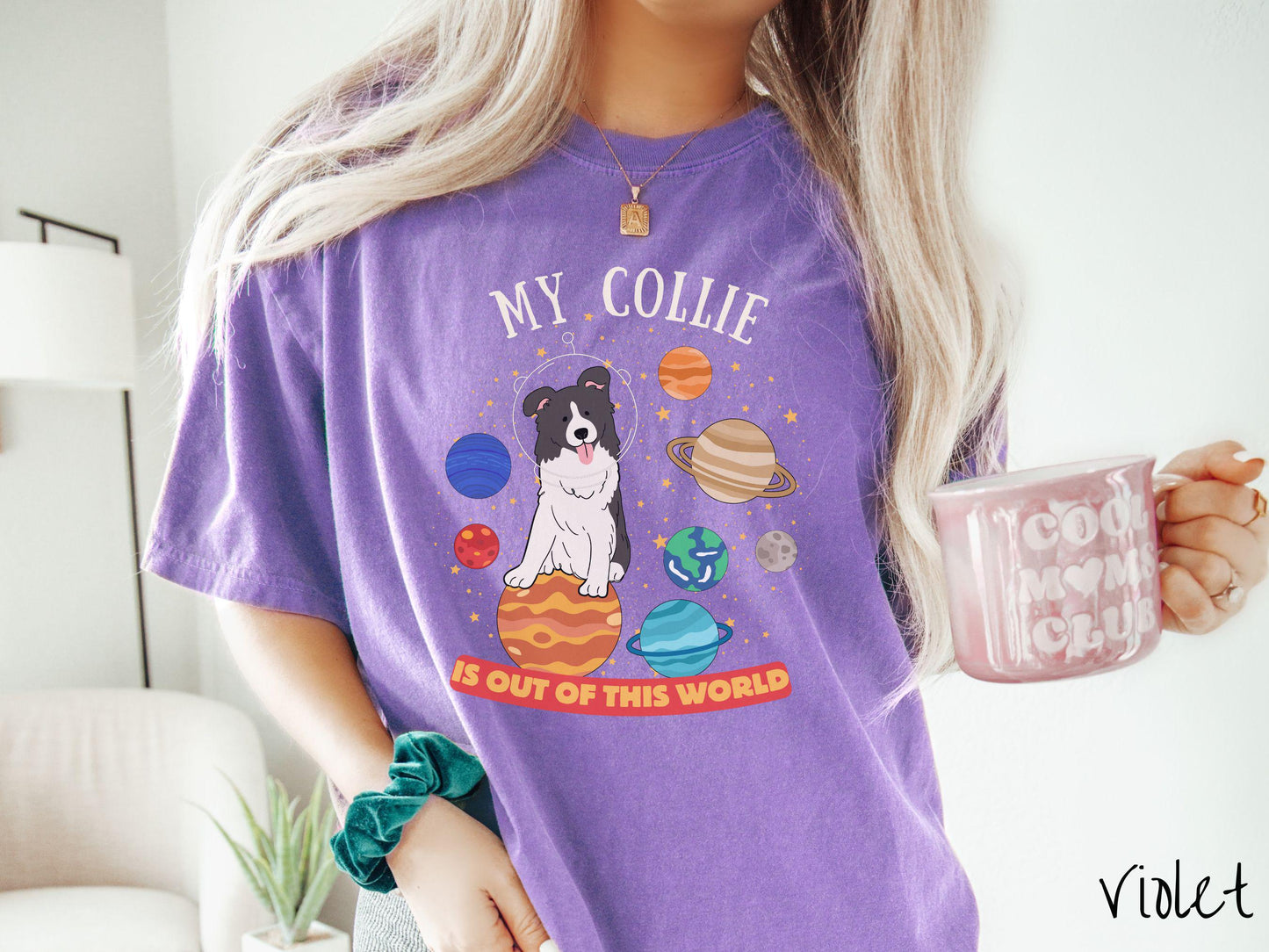 A vintage Comfort Colors t-shirt featuring the text My Collie is Out of This World. The design showcases an adorable Border Collie sitting proudly atop Jupiter, surrounded by a vibrant solar system filled with colorful planets and twinkling stars.