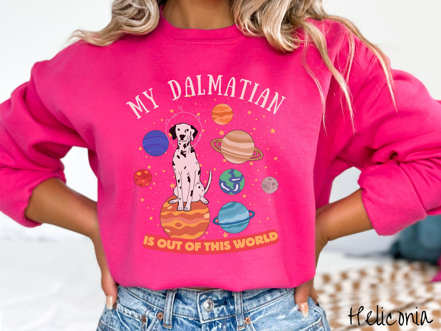 A vintage Gildan sweatshirt featuring the text My Dalmation is Out of This World. The design showcases a Dalmation sitting proudly atop Jupiter, surrounded by a vibrant solar system filled with colorful planets and twinkling stars.