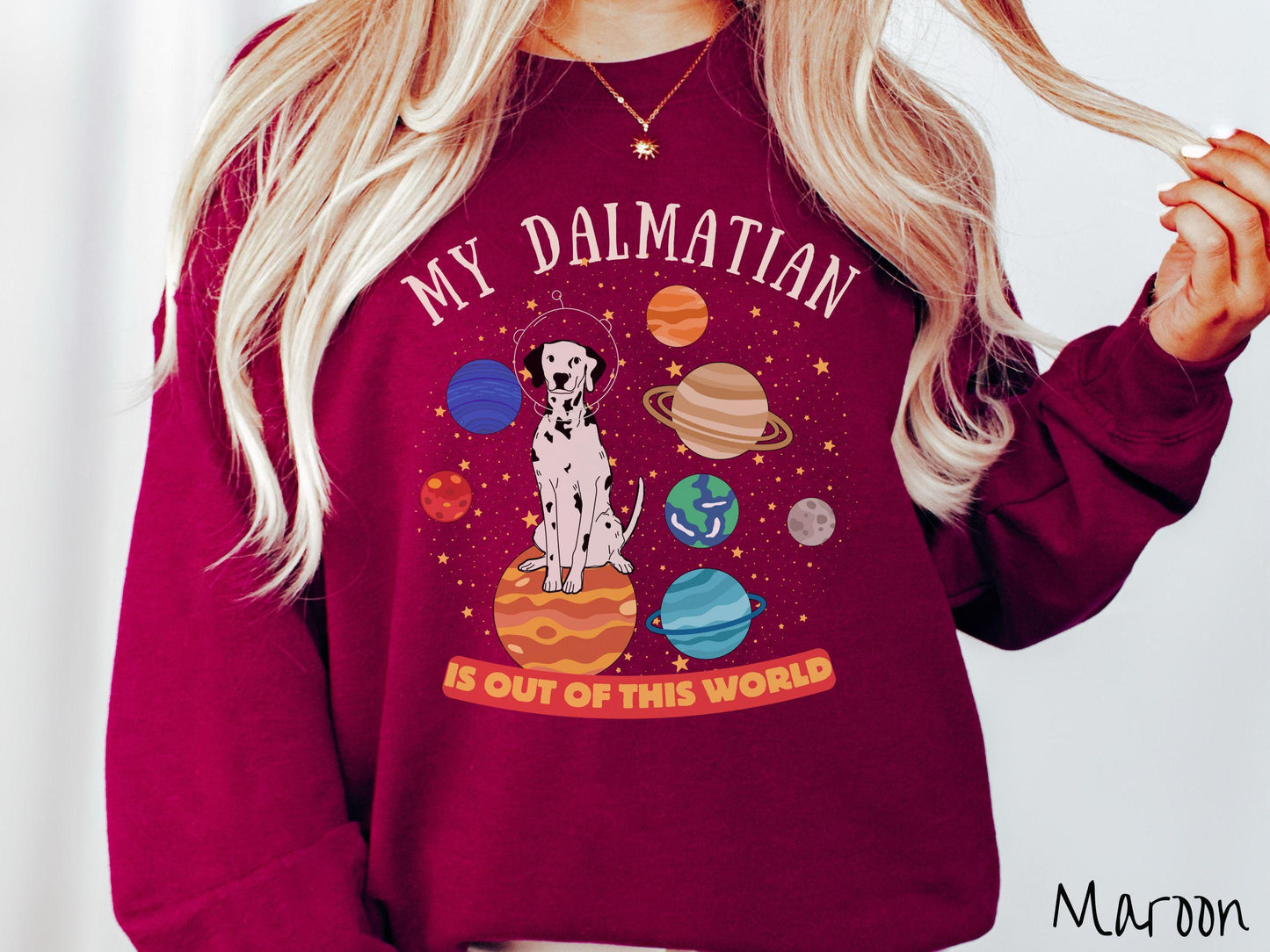 A vintage Gildan sweatshirt featuring the text My Dalmation is Out of This World. The design showcases a Dalmation sitting proudly atop Jupiter, surrounded by a vibrant solar system filled with colorful planets and twinkling stars.