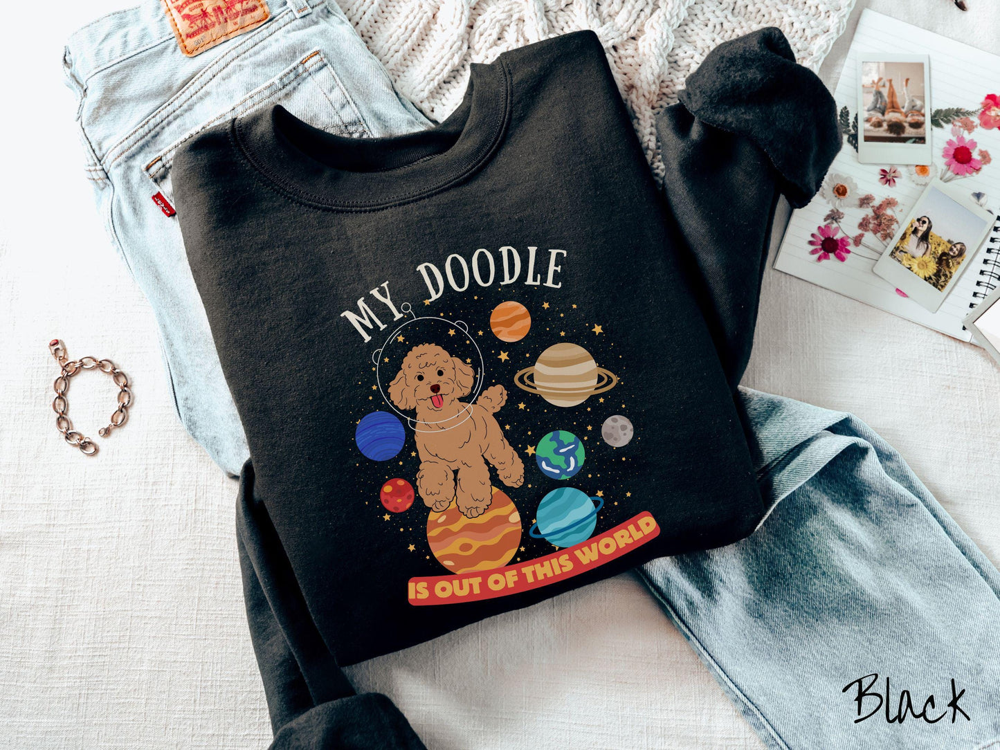 A vintage Gildan sweatshirt featuring the text My Doodle is Out of This World. The design showcases a German Shepherd sitting proudly atop Jupiter, surrounded by a vibrant solar system filled with colorful planets and twinkling stars.