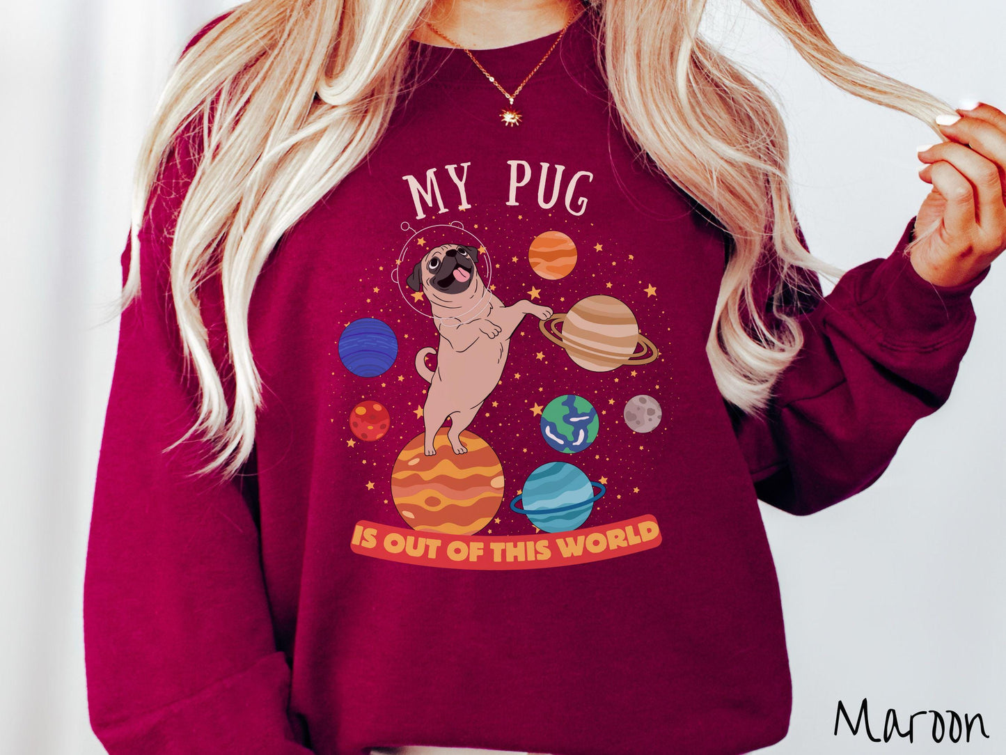 A vintage Gildan sweatshirt featuring the text My Pug is Out of This World. The design showcases an adorable Pug sitting proudly atop Jupiter, surrounded by a vibrant solar system filled with colorful planets and twinkling stars.