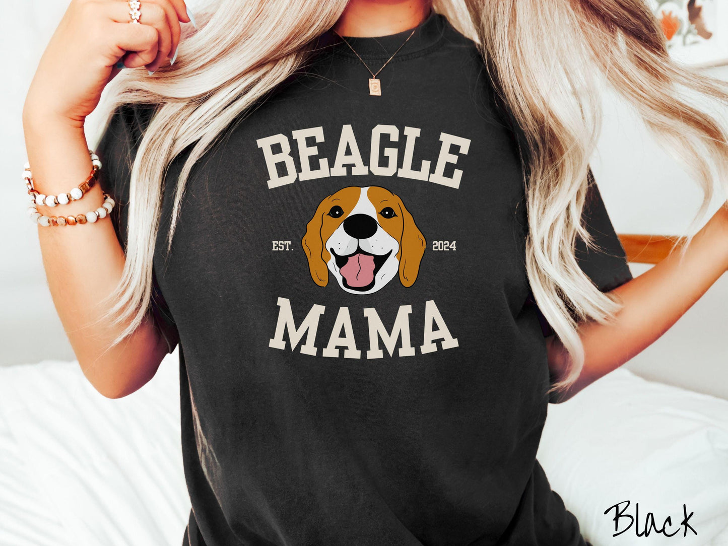 A vintage Comfort Colors t-shirt for every proud Beagle Mama! The design features the words Beagle Mama in a university-style font, framing an orange, black, and brown beagle. The playful touch of "EST. 2024" adds a personal charm to the design.