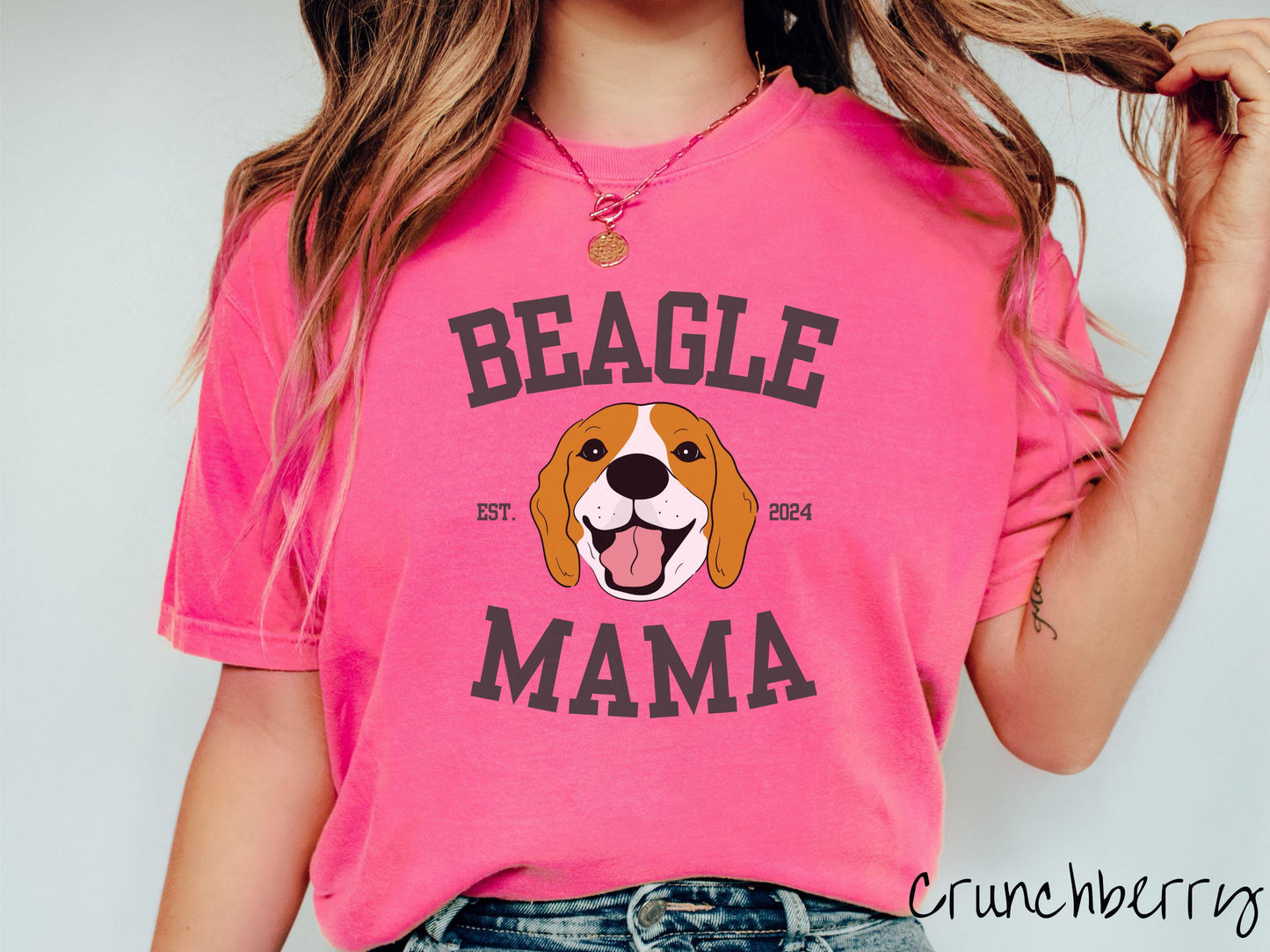 A vintage Comfort Colors t-shirt for every proud Beagle Mama! The design features the words Beagle Mama in a university-style font, framing an orange, black, and brown beagle. The playful touch of "EST. 2024" adds a personal charm to the design.