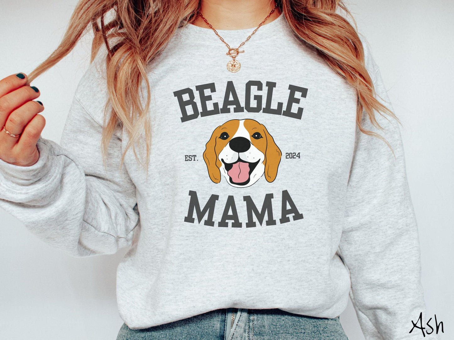 A vintage Gildan sweatshirt for every proud Beagle Mama! The design features the words Beagle Mama in a university-style font, framing an orange, black, and brown beagle. The playful touch of "EST. 2024" adds a personal charm to the design.