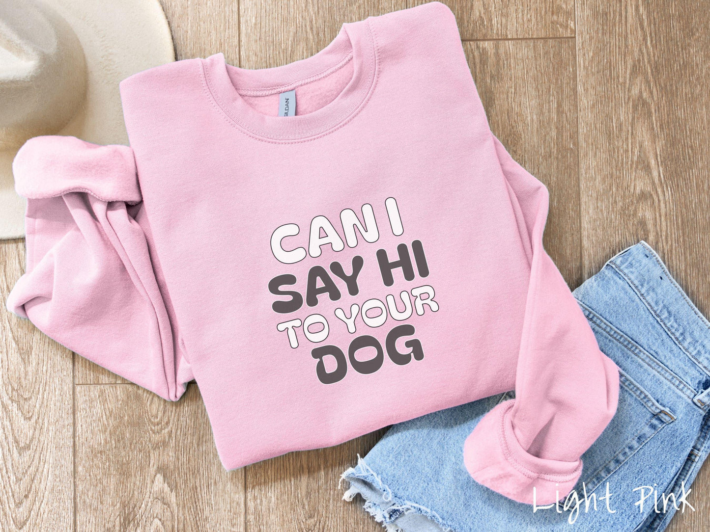 This vintage Gildan sweatshirt is perfect for dog lovers who want to make a bold statement. Featuring the text "CAN I SAY HI TO YOUR DOG" in uppercase black and white font, this sweater combines comfort and style with a playful message.