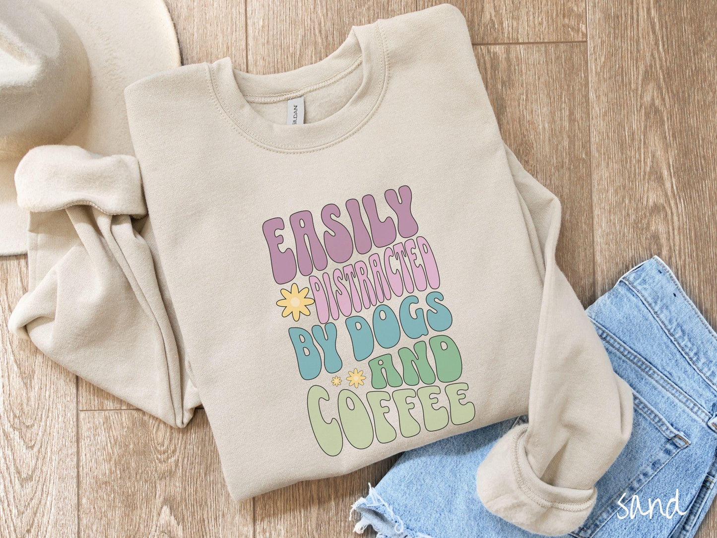 This vintage Gildan sweatshirt is a must-have for anyone who loves dogs, coffee, and a touch of humor! Featuring the funny saying Easily Distracted by Dogs and Coffee in vibrant, round font, this design adds a playful vibe to your wardrobe.