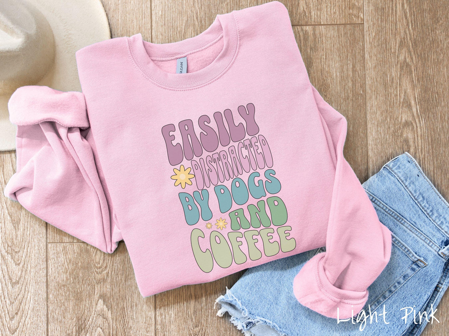 This vintage Gildan sweatshirt is a must-have for anyone who loves dogs, coffee, and a touch of humor! Featuring the funny saying Easily Distracted by Dogs and Coffee in vibrant, round font, this design adds a playful vibe to your wardrobe.