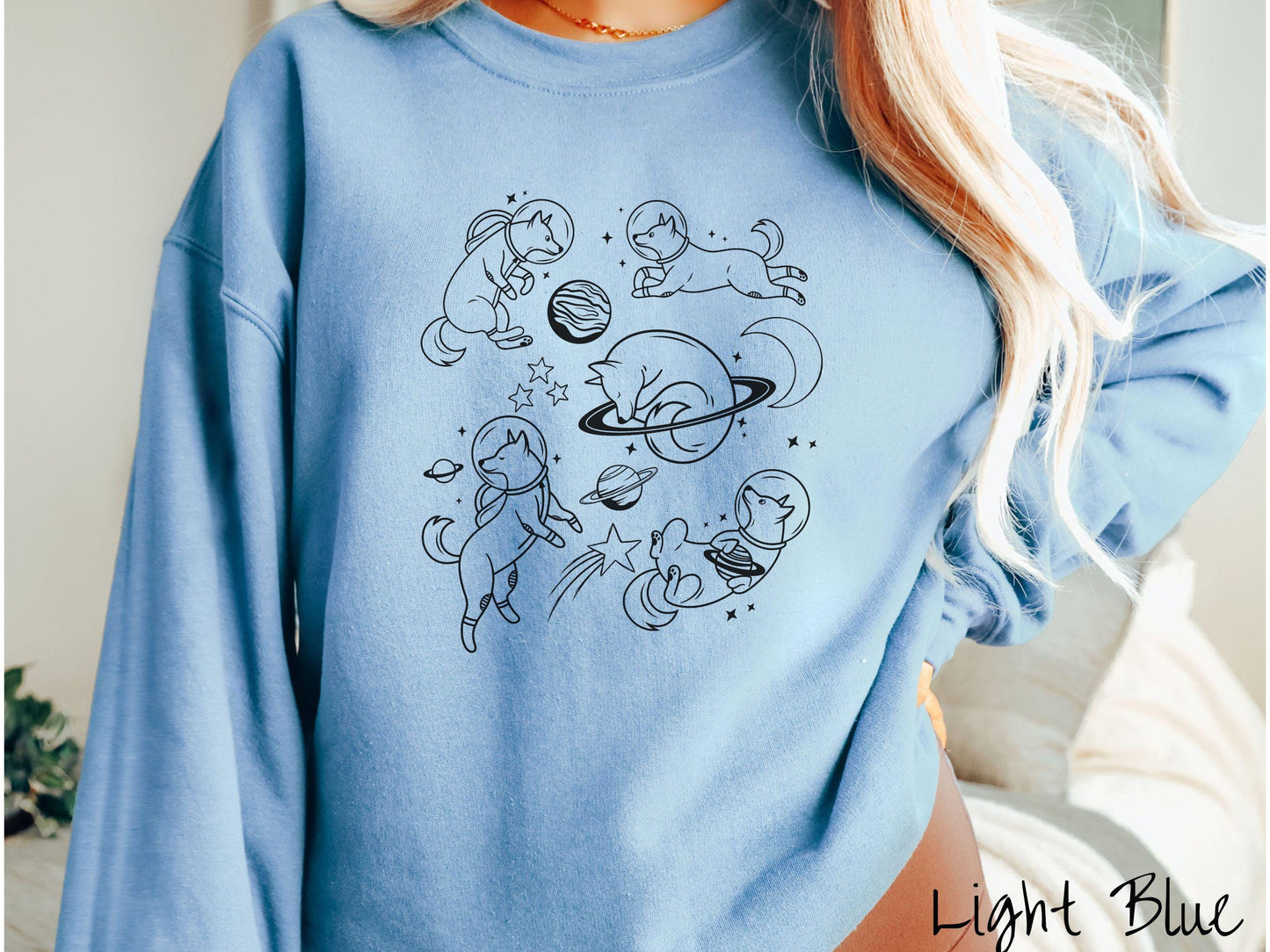 A vintage Gildan sweatshirt perfect for dog lovers and space enthusiasts alike, featuring outline designs of dogs in astronaut bubble helmets. This design showcases pups floating in the solar system, surrounded by stars, the moon, and planets.