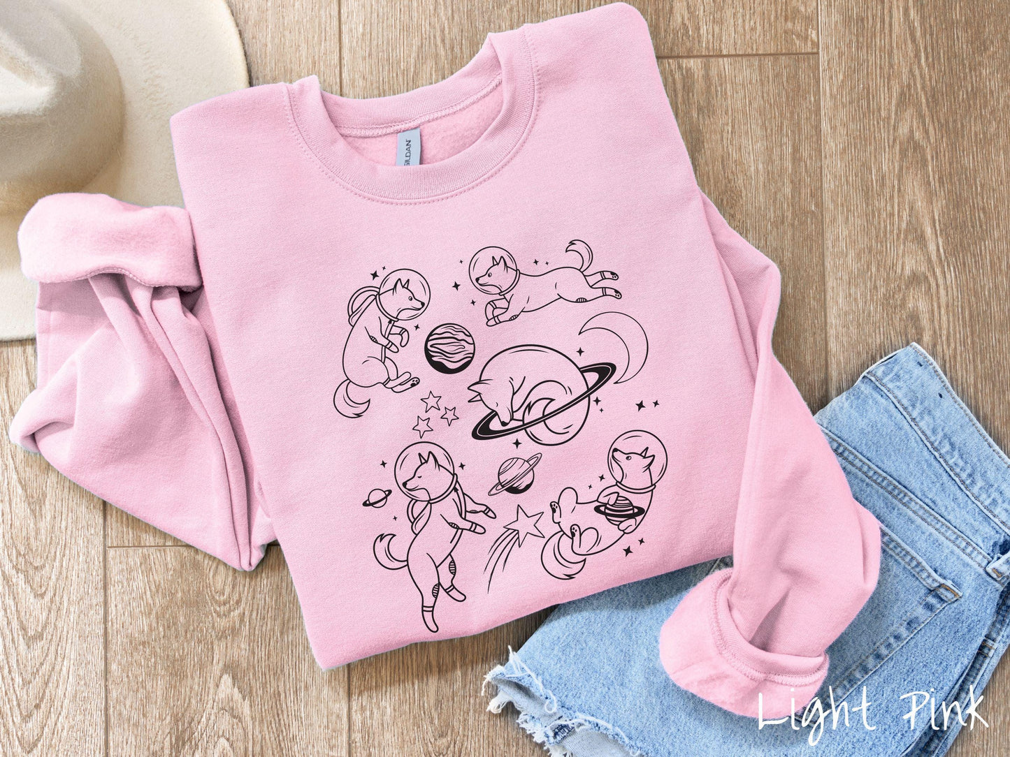 A vintage Gildan sweatshirt perfect for dog lovers and space enthusiasts alike, featuring outline designs of dogs in astronaut bubble helmets. This design showcases pups floating in the solar system, surrounded by stars, the moon, and planets.