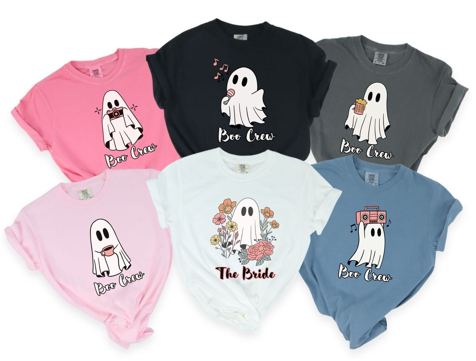 Multiple shirts in varying colors all with a woman wearing a cute crunchberry colored shirt with the text Boo Crew under a ghost figure holding a camera.