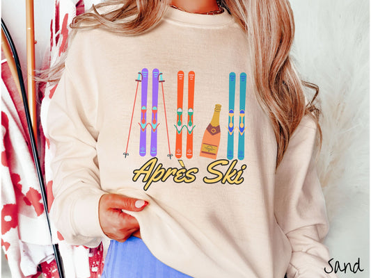 A woman wearing a vintage, sand colored sweatshirt with sets of purple, orange, and turquoise snow skis standing upright, and a big bottle of champagne next to them. Below the skis is the text Apres Ski which is French for After Skiing.