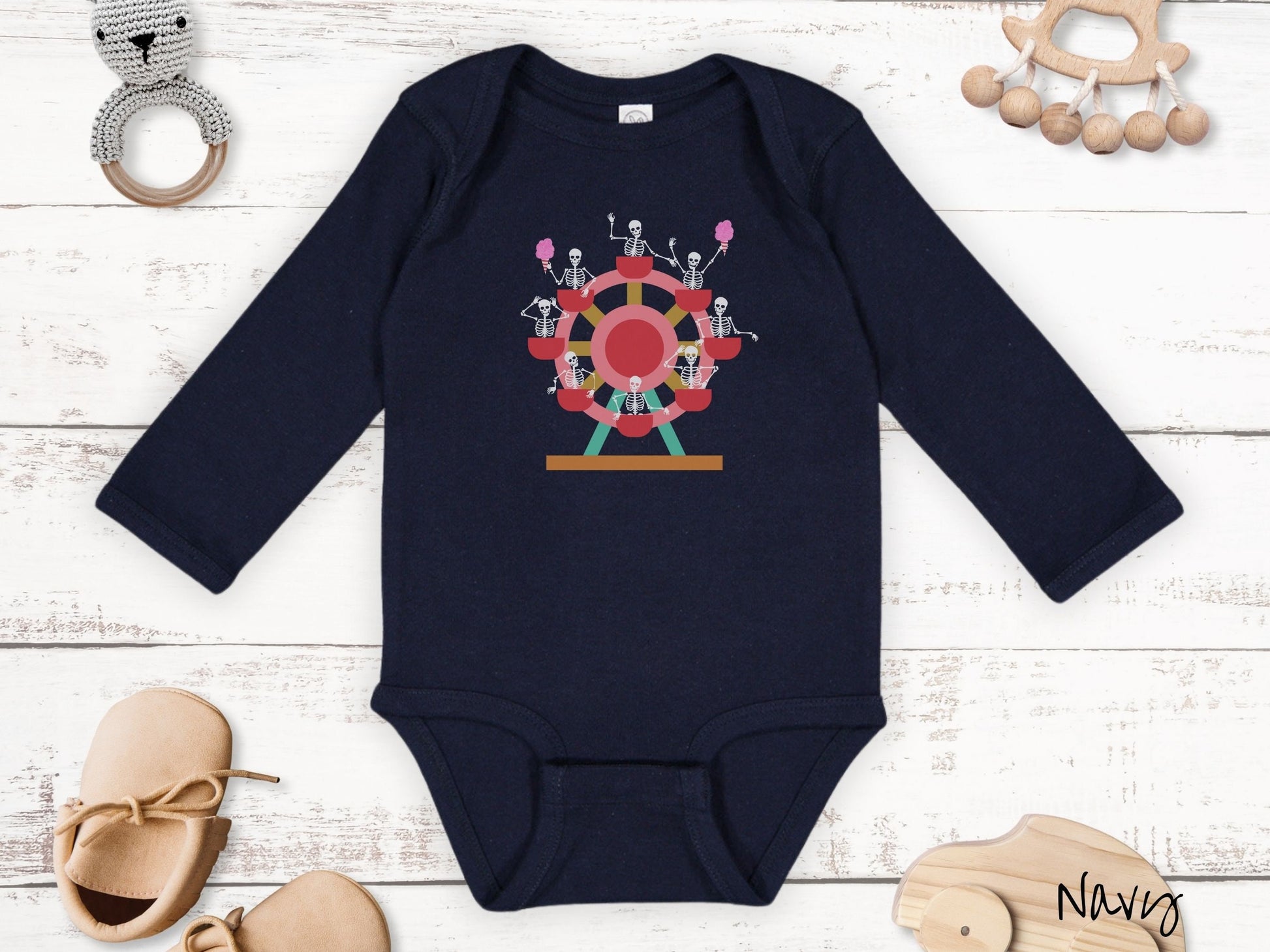 A cute navy colored body suit with a ferris wheel filled with black skeletons waving and holding cotton candy as they go around the ride.