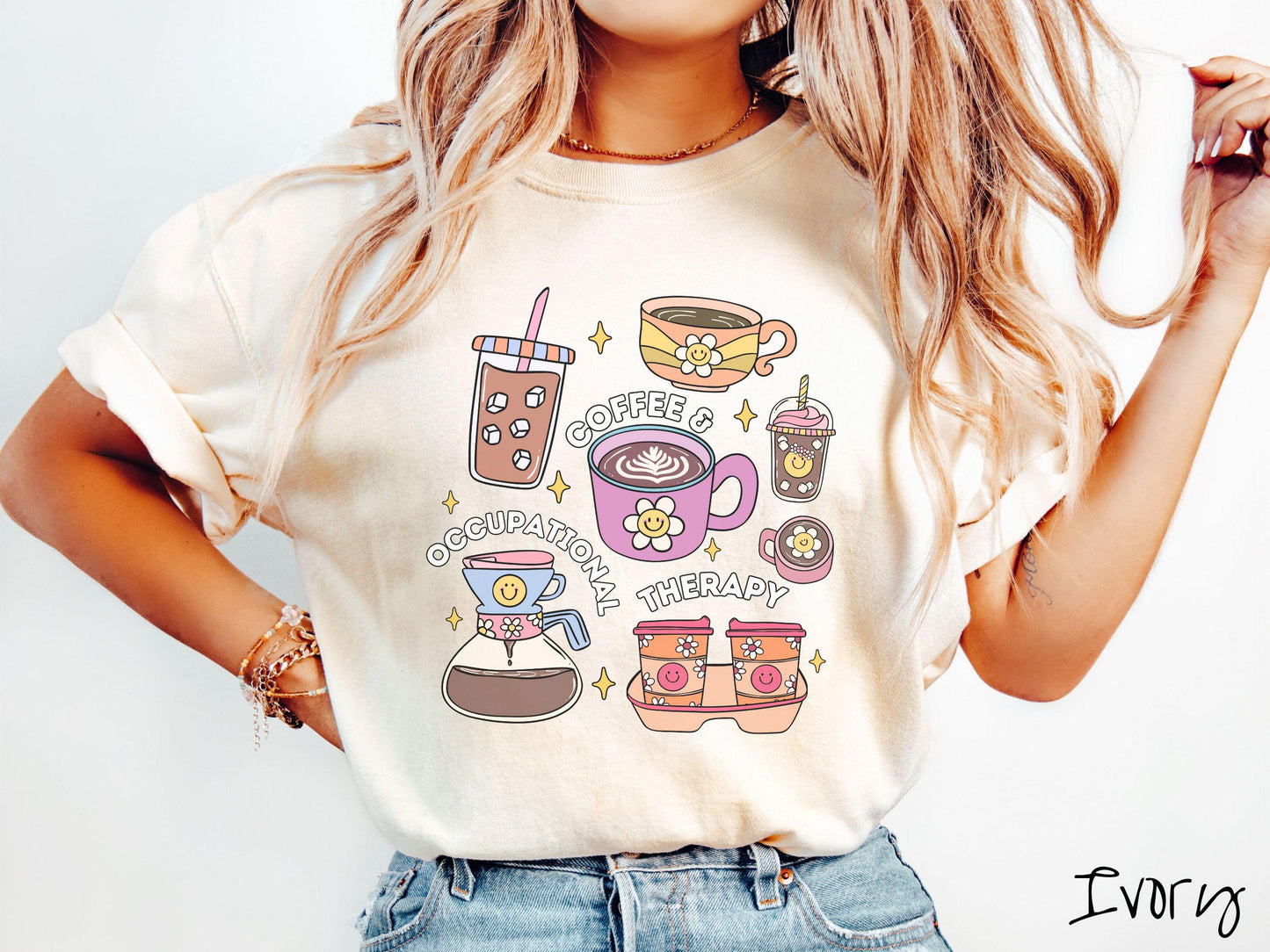 A woman wearing a cute, vintage ivory colored Comfort Colors T-shirt with the text Coffee and Occupational Therapy. There is an iced coffee, two hot coffees, a blended coffee drink with whipped cream, to-go coffees, and a pot of coffee.