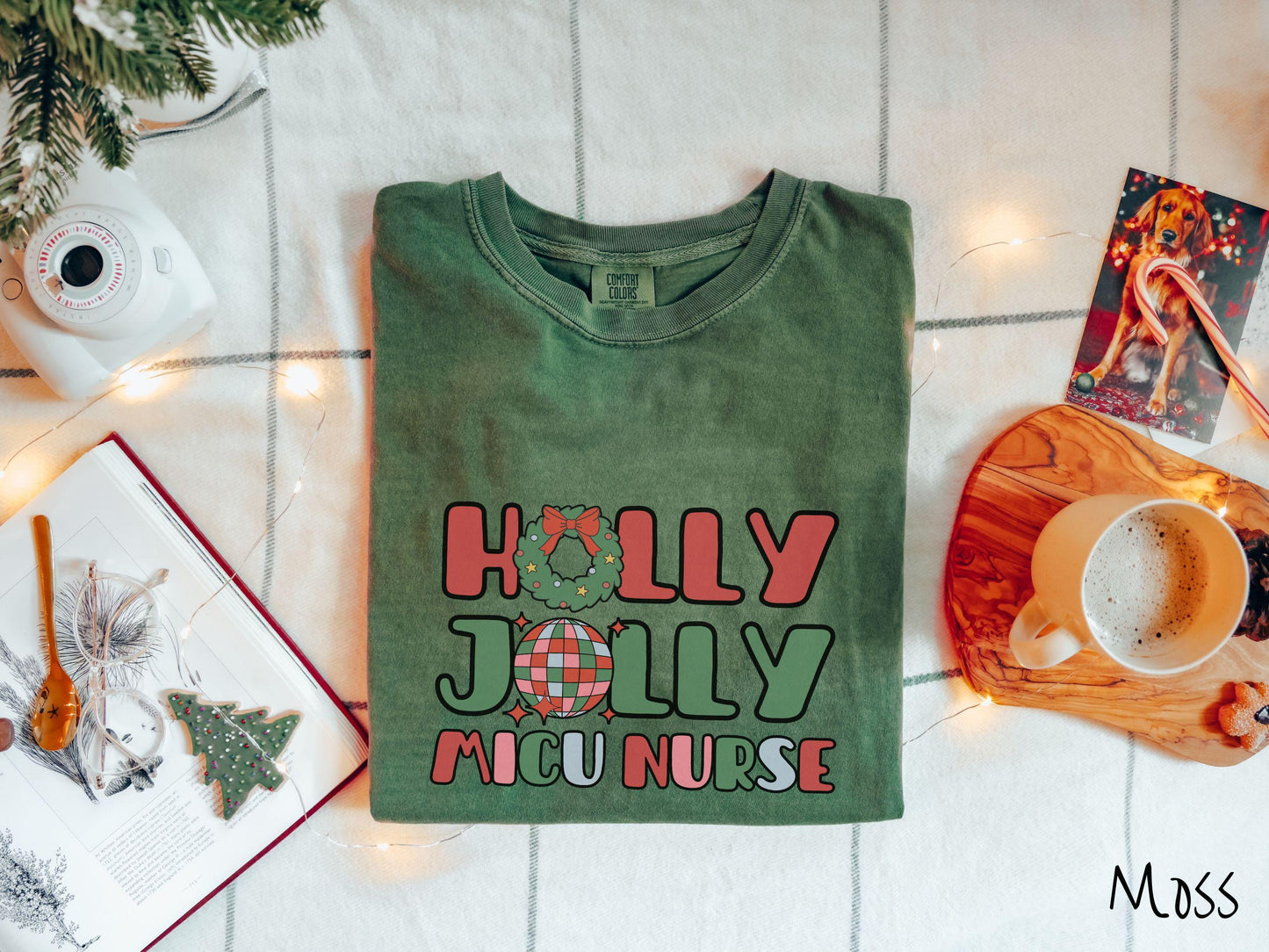 A cute, vintage moss colored Comfort Colors T-shirt with the text Holly Jolly MICU Nurse in red, green, pink, and blue font. The letter O in Holly is a Christmas wreath and the letter O in Jolly is a multi-colored disco ball.