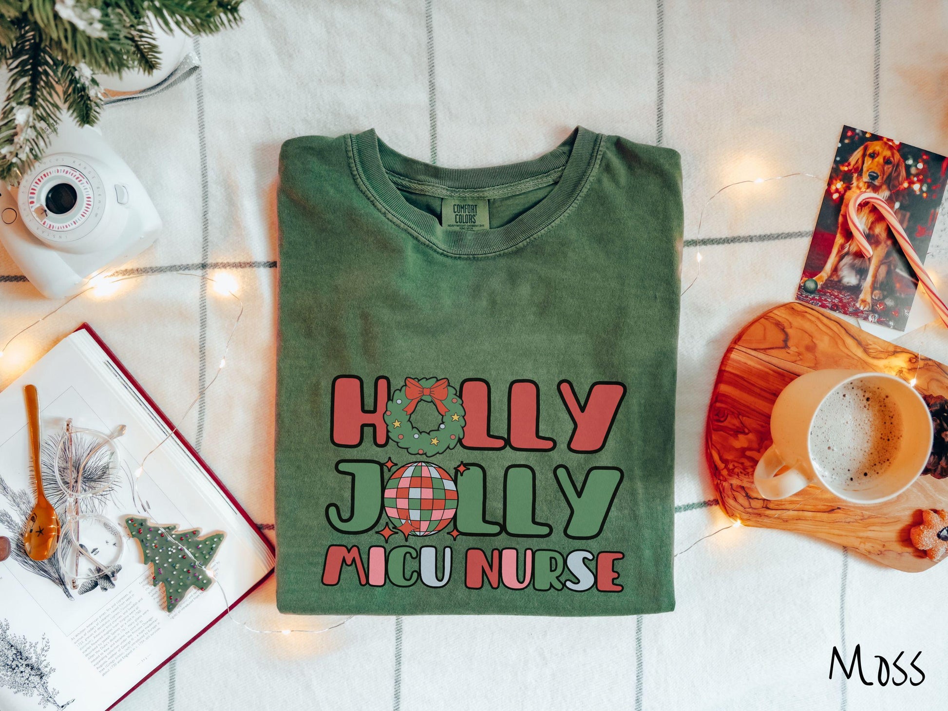 A cute, vintage moss colored Comfort Colors T-shirt with the text Holly Jolly MICU Nurse in red, green, pink, and blue font. The letter O in Holly is a Christmas wreath and the letter O in Jolly is a multi-colored disco ball.
