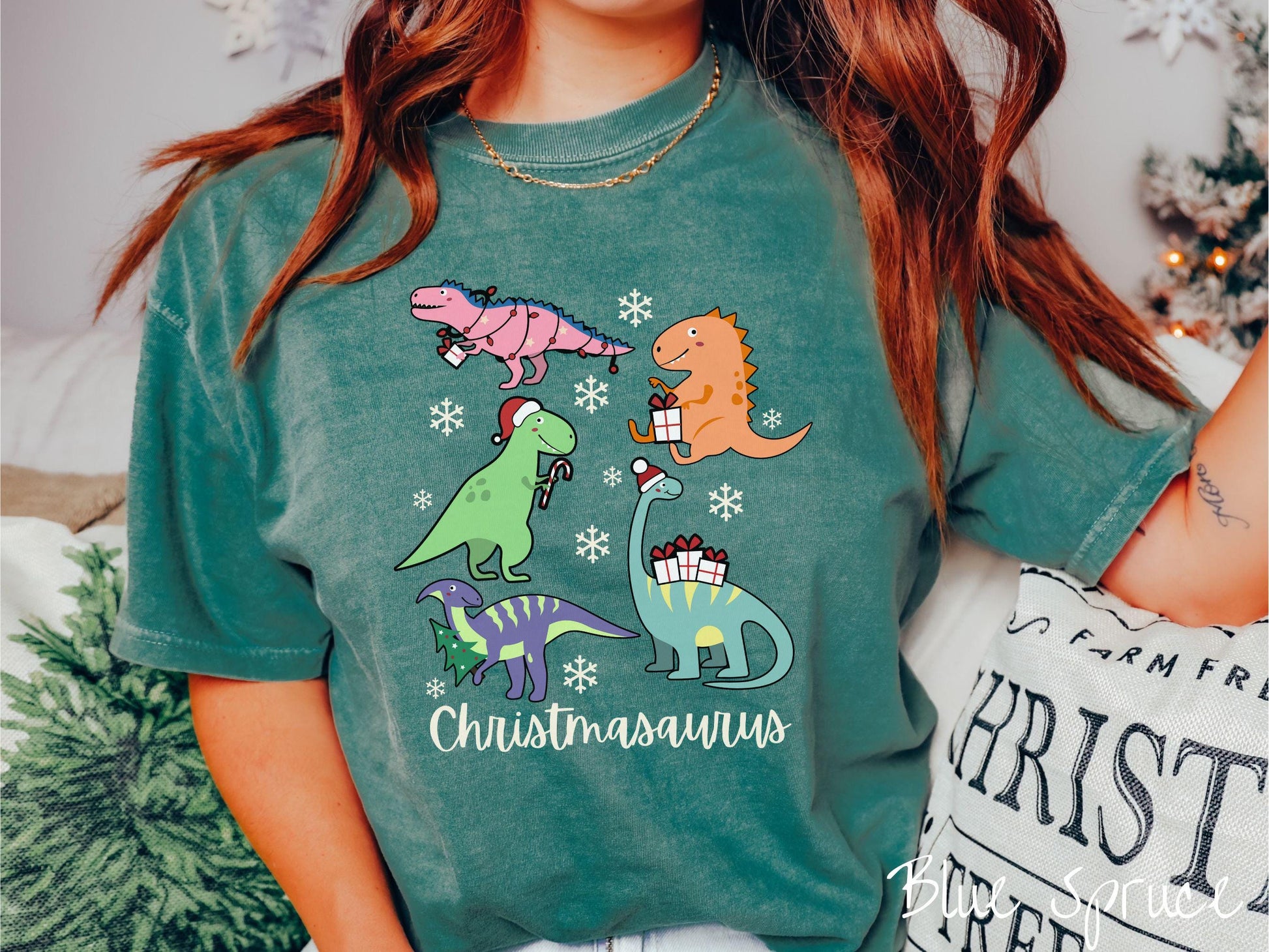 Get into the festive spirit with this adorable blue spruce colored Christmasaurus Comfort Colors T-shirt. Featuring a variety of colorful dinosaurs dressed up for the holidays, this tee exudes a playful and cheerful vibe.