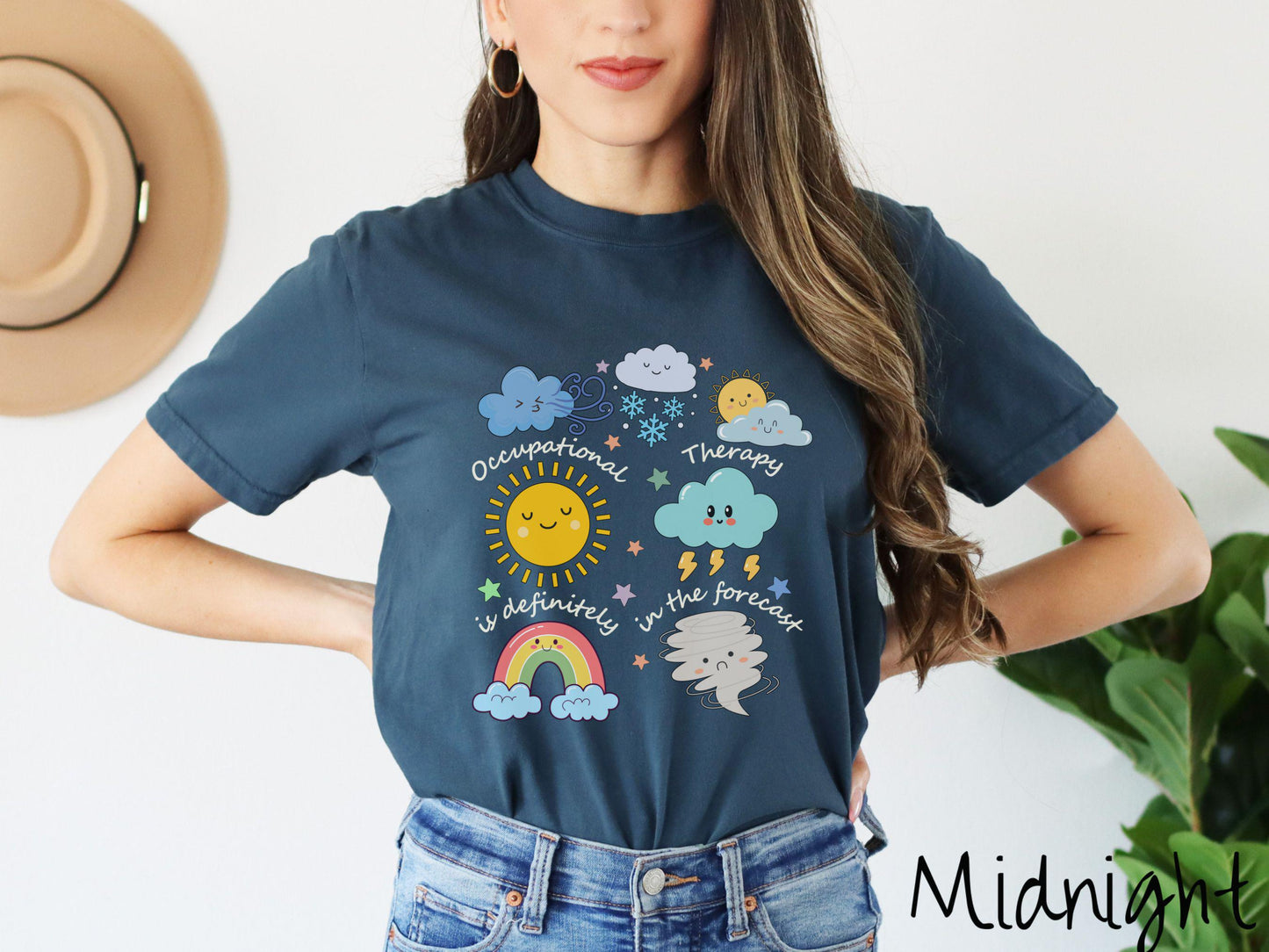 A vintage, midnight colored Comfort Colors T-shirt featuring the text Occupational Therapy is definitely in the forecast and surrounded by weather elements like clouds, rain clouds, a shining sun, lightning, a rainbow, and a tornado.