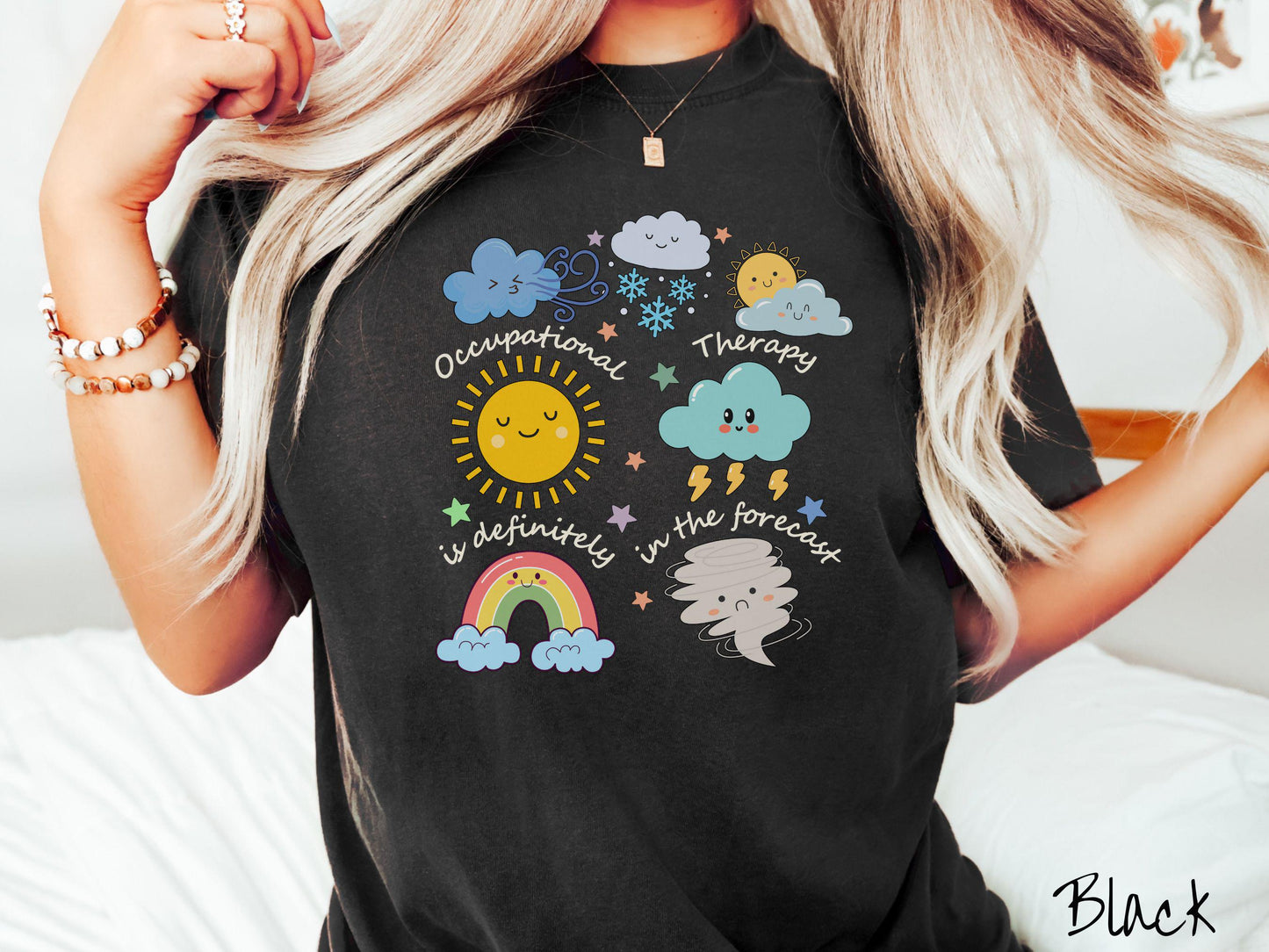 A vintage, black colored Comfort Colors T-shirt featuring the text Occupational Therapy is definitely in the forecast and surrounded by weather elements like clouds, rain clouds, a shining sun, lightning, a rainbow, and a tornado.