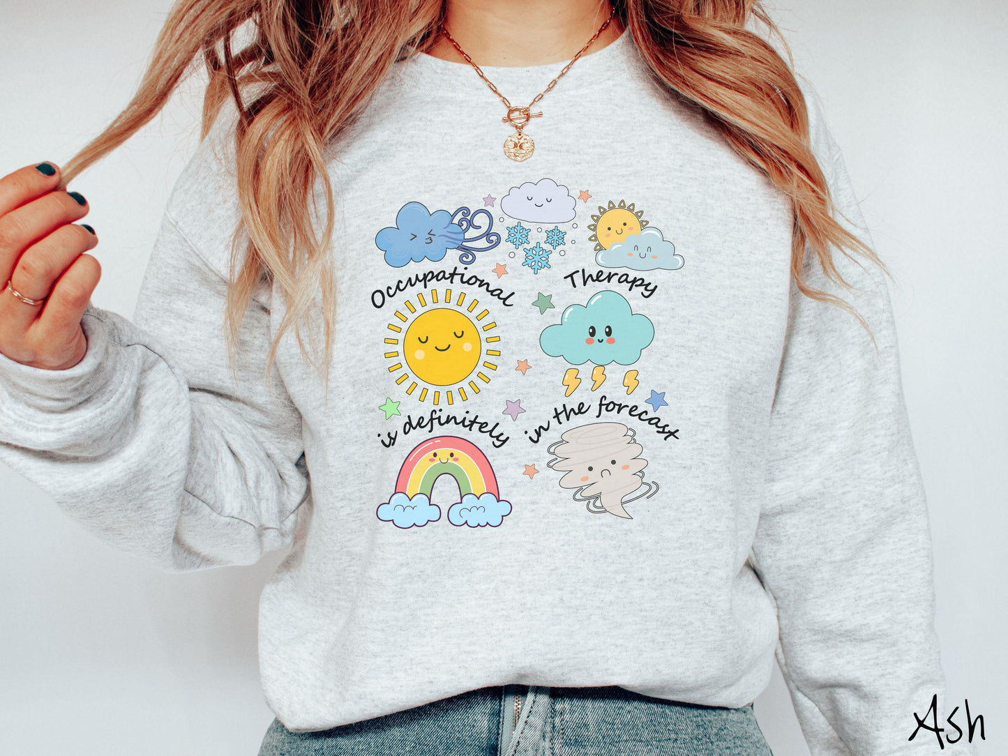 A vintage, ash colored Gildan sweatshirt featuring the text Occupational Therapy is definitely in the forecast and surrounded by weather elements like clouds, rain clouds, a shining sun, lightning, a rainbow, and a tornado.