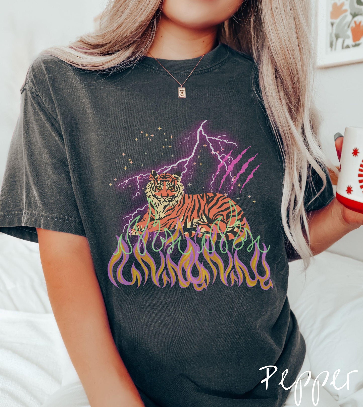 A vintage Comfort Colors t-shirt with a majestic tiger design above colorful flames and lightning. The relaxed fit and classic crew neckline make it perfect for casual or semi-formal wear.