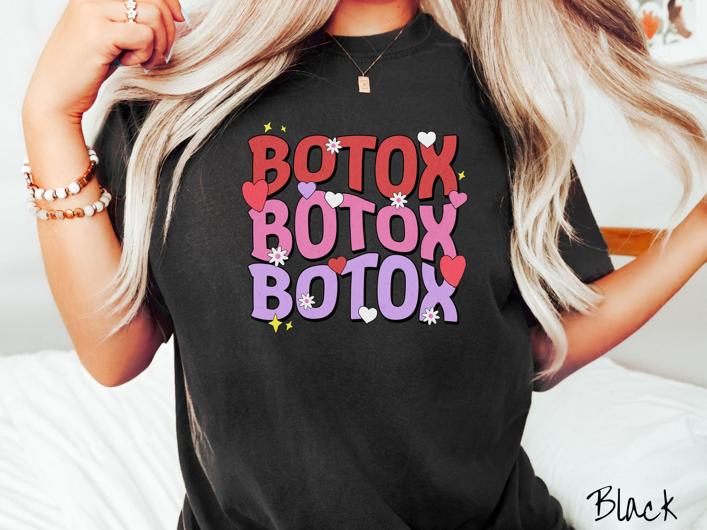 A vibrant Comfort Colors T-shirt with the text BOTOX written three times vertically, accompanied by tiny hearts, stars, and flowers. The perfect gift for friends who are into cosmetic botox nursing.