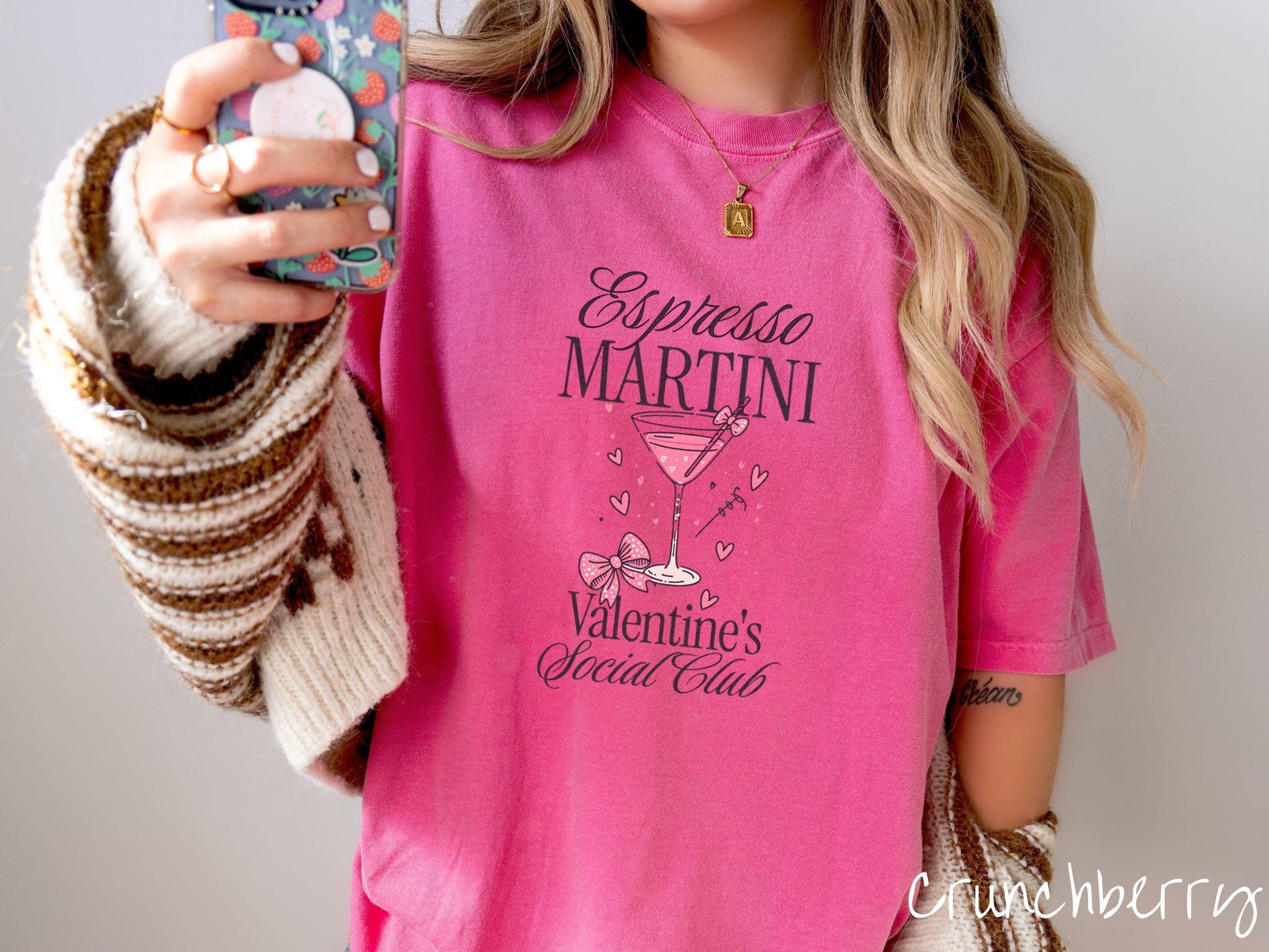 A stylish Comfort Colors T-shirt featuring the phrase &quot;Espresso Martini&quot; above a martini glass filled with pink martini a pink bow-topped toothpick. The words &quot;Valentine&#39;s Social Club&quot; appear below, with pink bows and hearts throughout the design.