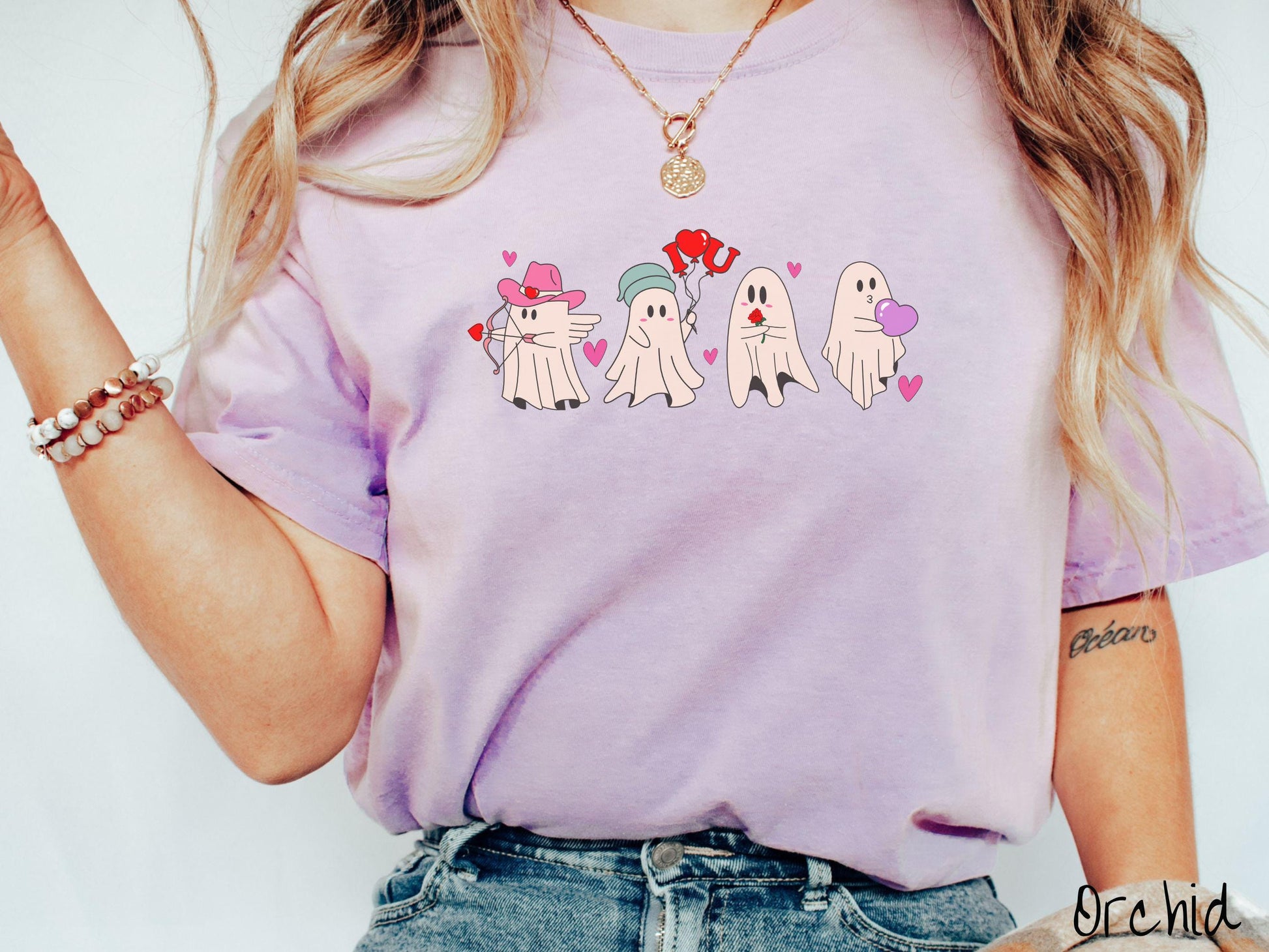 A vintage Comfort Colors t-shirt featuring four adorable ghosts with romantic details like a cowboy hat, heart-tipped arrows, &quot;I Love You&quot; balloons, a red rose, and a purple heart balloon, plus pink hearts for a whimsical touch.