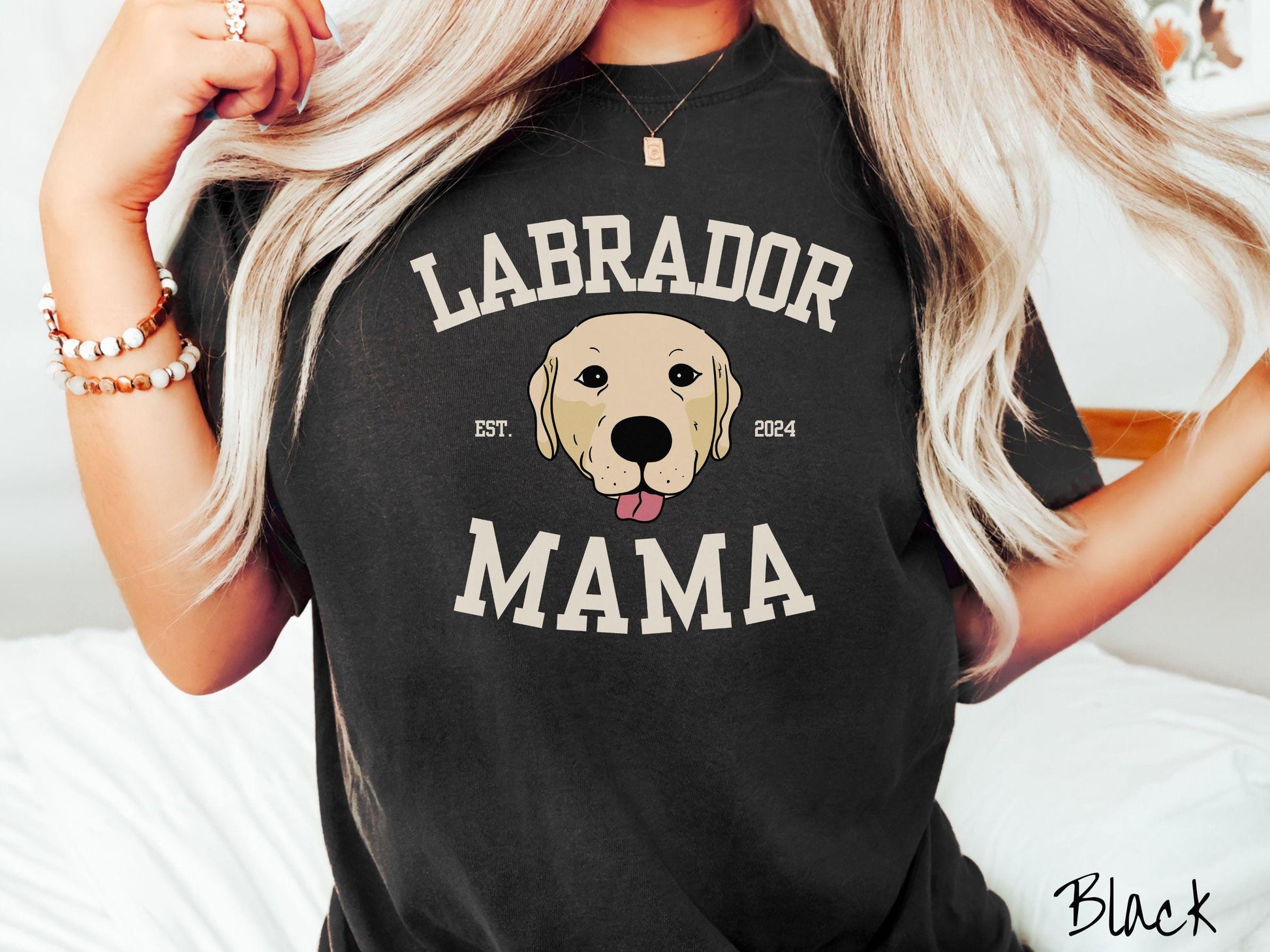 A vintage Comfort Colors t-shirt featuring bold block lettering that reads &#39;Labrador Mama.&#39; At the center of the design, a playful yellow Labrador with its tongue out steals the spotlight, framed by the stylish text &#39;EST. 2024.&#39;