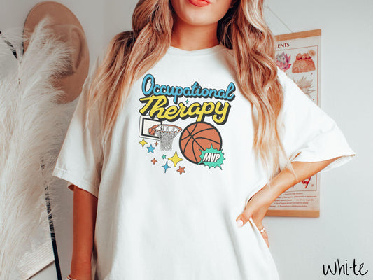 A vintage, white colored Comfort Colors T-Shirt features the phrase &quot;Occupational Therapy&quot; above a basketball goal, complemented by a bold basketball graphic with the text &quot;MVP&quot;.