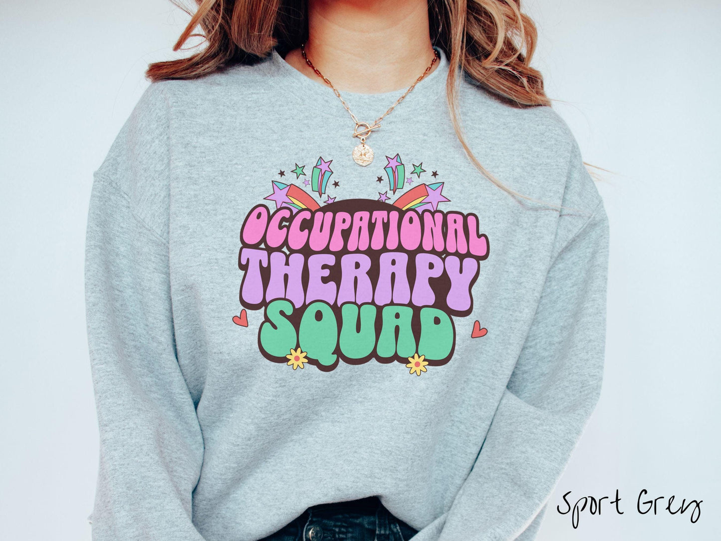 A vintage, sport grey colored Gildan sweatshirt with the text Occupational Therapy Squad in colorful font with red hearts, sunflowers, and shooting stars mixed in.