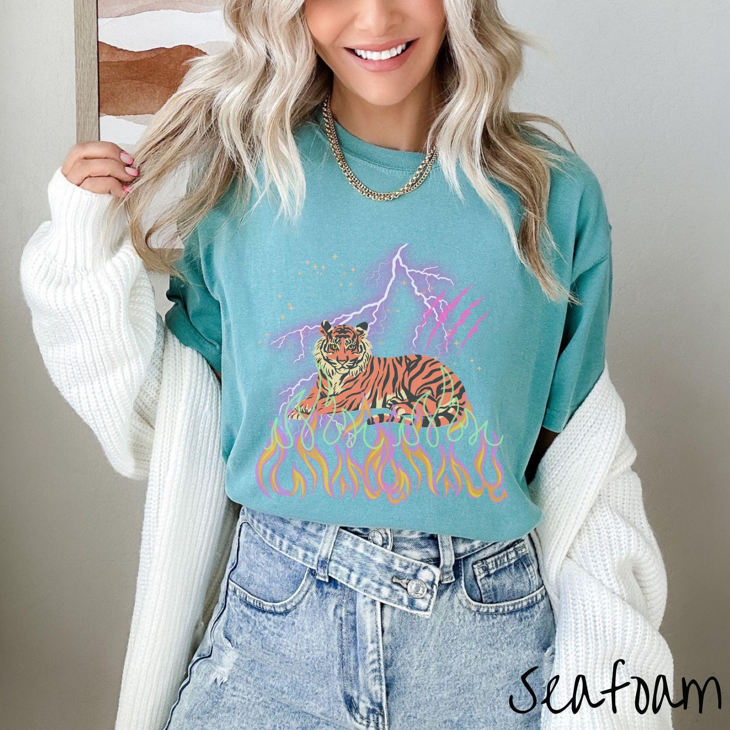 A vintage Comfort Colors t-shirt with a majestic tiger design above colorful flames and lightning. The relaxed fit and classic crew neckline make it perfect for casual or semi-formal wear.