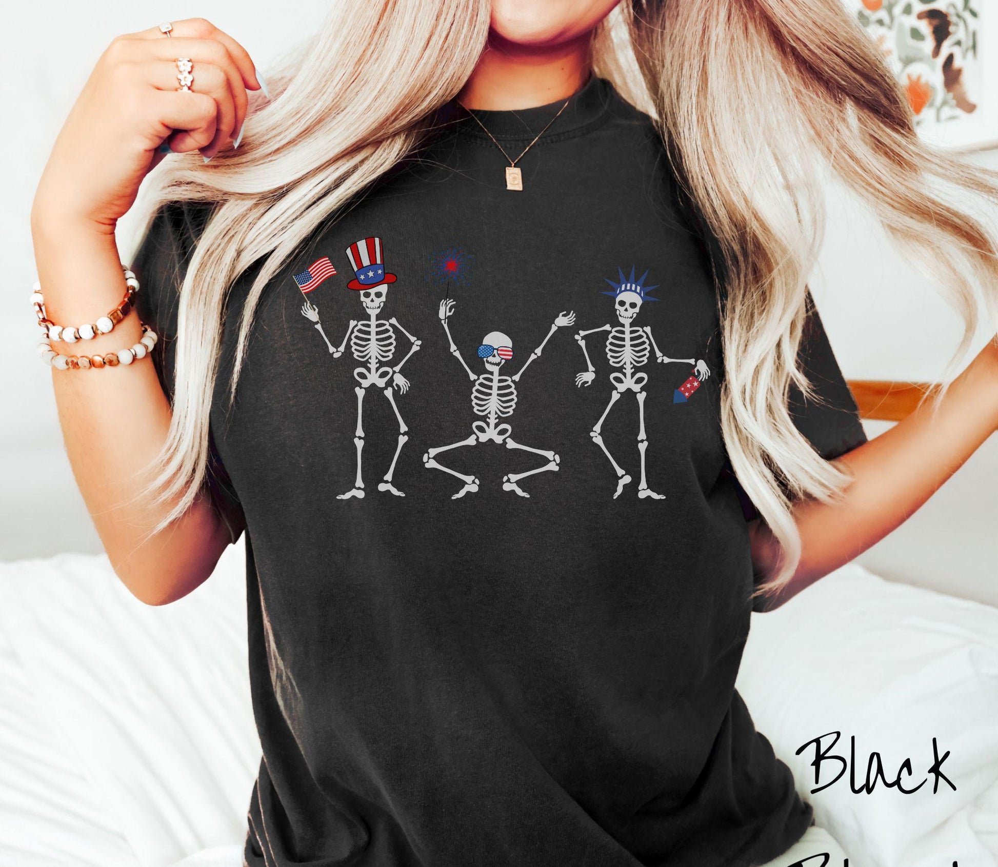 Celebrate in style with this vintage-inspired tee featuring three dancing skeletons decked out in red, white, and blue hats. They hold American flags, sparklers, and fireworks, making it the perfect shirt for Fourth of July celebrations.