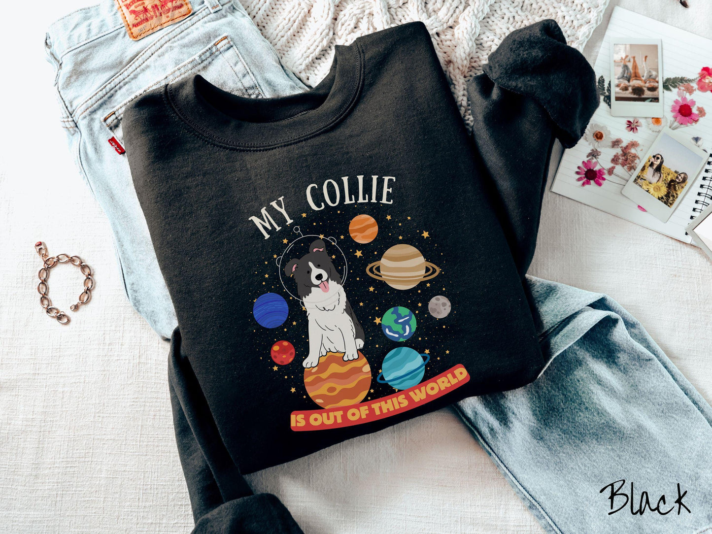 A vintage Gildan sweatshirt featuring the text My Collie is Out of This World. The design showcases an adorable Border Collie sitting proudly atop Jupiter, surrounded by a vibrant solar system filled with colorful planets and twinkling stars.