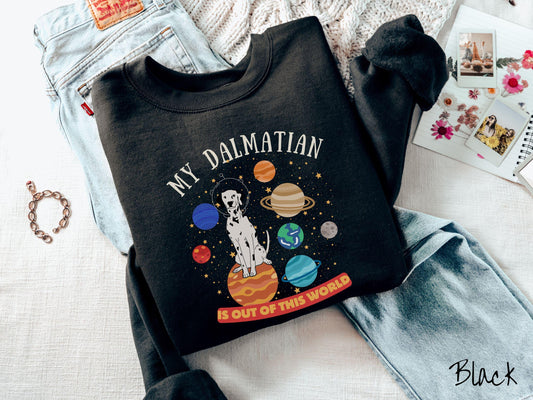 A vintage Gildan sweatshirt featuring the text My Dalmation is Out of This World. The design showcases a Dalmation sitting proudly atop Jupiter, surrounded by a vibrant solar system filled with colorful planets and twinkling stars.
