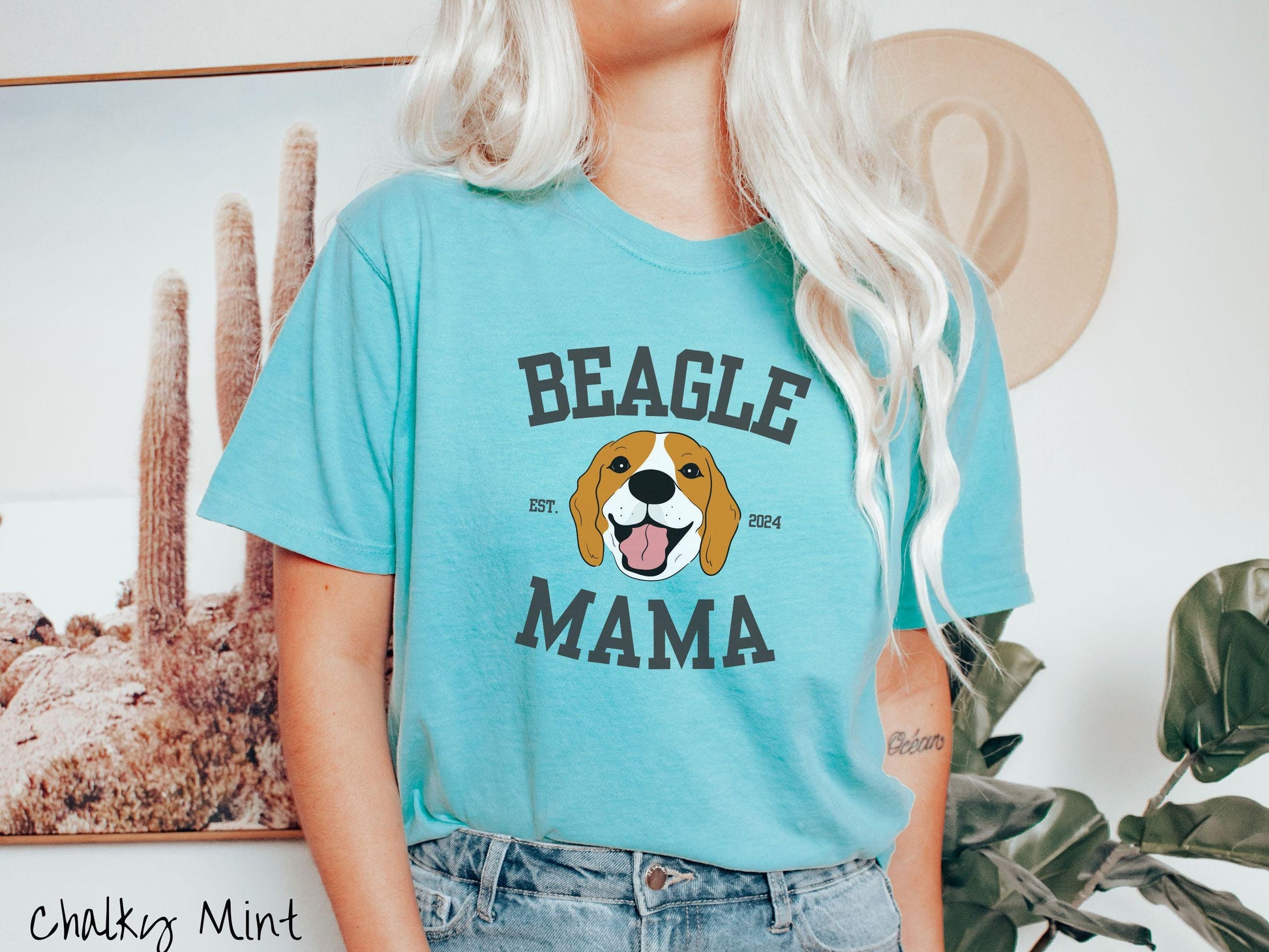 A vintage Comfort Colors t-shirt for every proud Beagle Mama! The design features the words Beagle Mama in a university-style font, framing an orange, black, and brown beagle. The playful touch of "EST. 2024" adds a personal charm to the design.