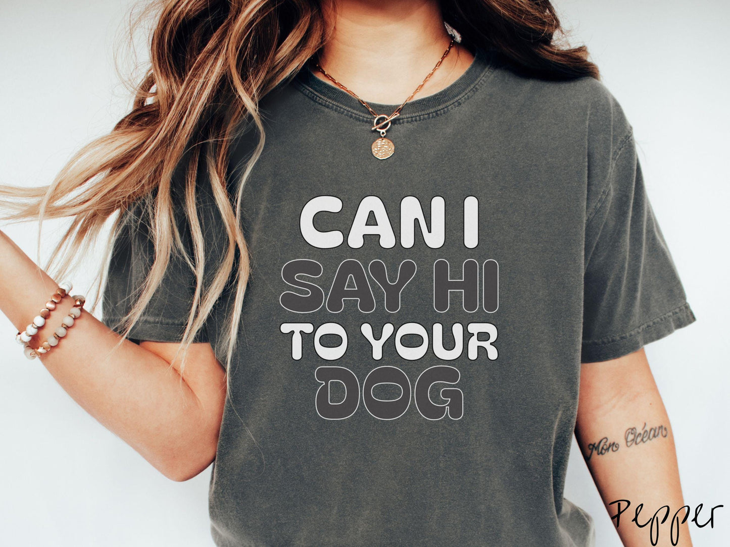 This vintage Comfort Colors t-shirt is perfect for dog lovers who want to make a bold statement. Featuring the text "CAN I SAY HI TO YOUR DOG" in uppercase black and white font, this shirt combines comfort and style with a playful message.