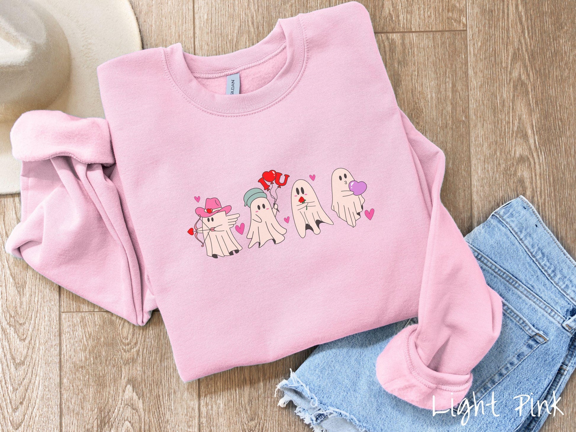 A vintage Gildan sweatshirt featuring four adorable ghosts with romantic details like a cowboy hat, heart-tipped arrows, &quot;I Love You&quot; balloons, a red rose, and a purple heart balloon, plus pink hearts for a whimsical touch.