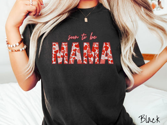 Celebrate your journey to motherhood with this vintage Comfort Colors t-shirt featuring the phrase “Soon to Be Mama” in bold red font, and the word “Mama” stands out in block letters filled with colorful hearts for a playful and charming touch.