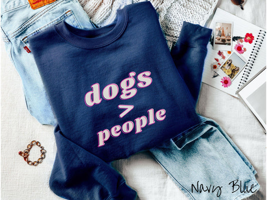A vintage Gildan sweatshirt is perfect for dog lovers who know that dogs are greater than people! Featuring the funny saying Dogs &gt; People, this tee is a must-have for anyone who prefers the company of their furry friends over humans.