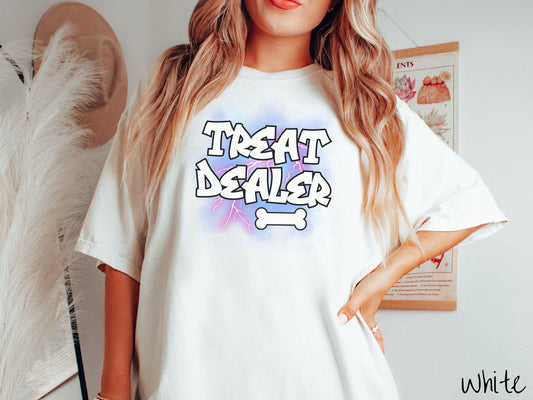 A vintage Comfort Colors t-shirt for dog lovers who always have treats on hand! Featuring the playful text Treat Dealer in graffiti-style white font, this design makes a fun statement for pet parents, dog trainers, and anyone who spoils their pup.